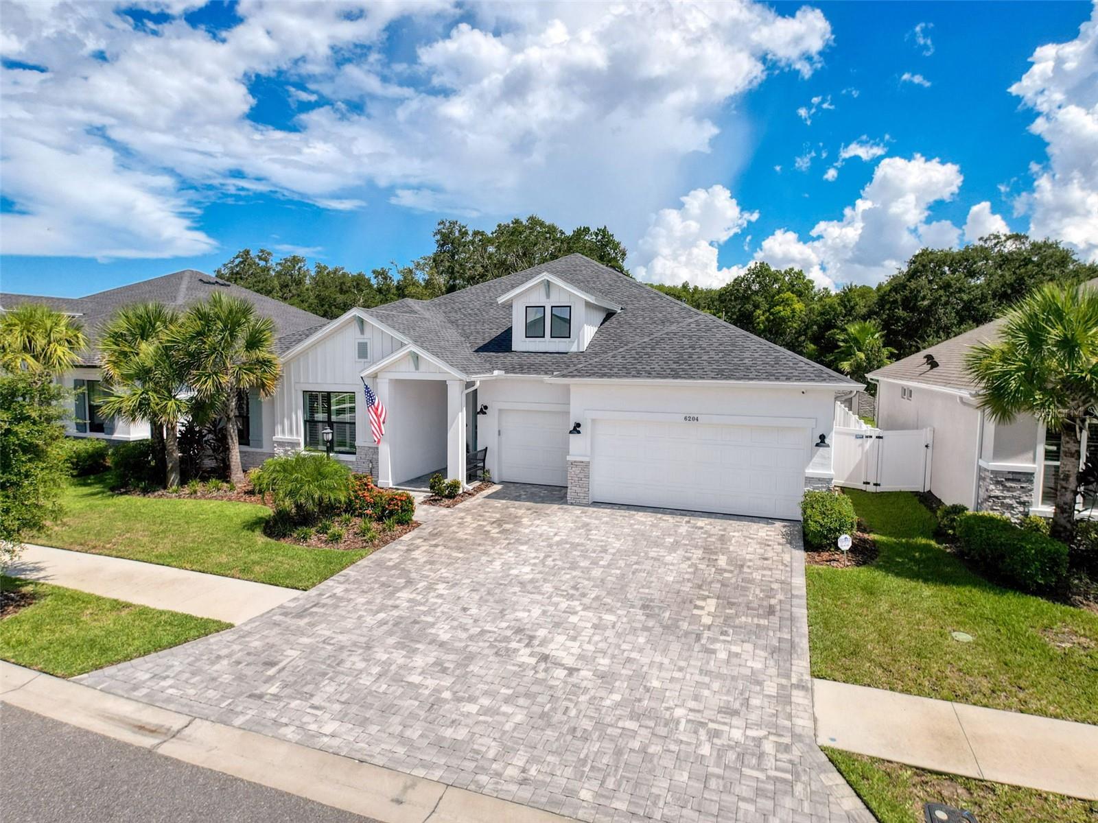 Under contract-accepting backup offers. Welcome to elegance of 6204 Nikki Lane, nestled within the exclusive gated enclave of Copeland Creek in Odessa, FL. This exquisite David Weekley estate boasts over 3,200 square feet of impeccably crafted living space, featuring 4 generously sized bedrooms, 3.5 designer bathrooms, a private home office with French doors, and a versatile bonus room — all thoughtfully curated for elevated living. Soaring 10-foot ceilings, rich natural light, and a custom-built fireplace create an atmosphere of sophistication and warmth, while the expansive open-concept layout seamlessly connects the living, dining, and chef’s kitchen — a true entertainer’s dream.
Every detail exudes luxury, from the upgraded designer lighting in the dining room, kitchen, and hallways, to the sleek sliding barn door and elegant plantation shutters. This residence is also thoughtfully pre-plumbed for a future outdoor kitchen, offering endless outdoor possibilities. Recent high-end enhancements include seamless gutters, a privacy fence, ceiling fans added to all bedrooms, living areas, the bonus room, and the covered patio, as well as a premium water softener system, custom garage storage, and a state-of-the-art full home security system with outdoor surveillance.
Perfectly situated on a quiet interior street and zoned for top rated schools, this home offers an unmatched combination of luxury, security, and convenience. Moments from fine dining, boutique shopping, and major thoroughfares, this is Florida living at its finest. Don’t miss the opportunity to own one of Copeland Creek’s most distinguished residences.