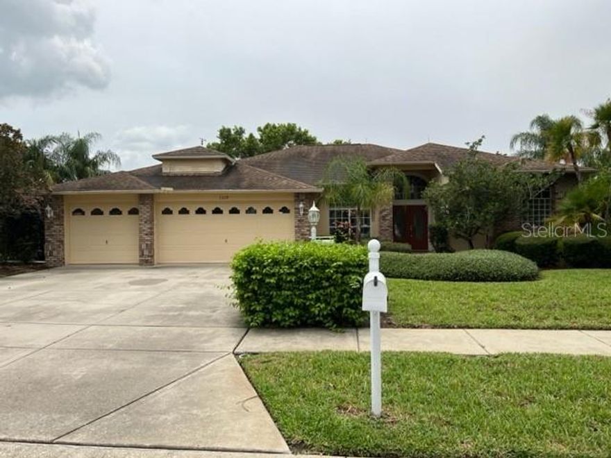 ** PRICE DRASTICALLY REDUCED FOR QUICK SALE** Country Club living at its best! This 3/2/3 car garage home with a beautiful brick accent elevation is situated on a corner lot in sought after Heritage Springs, a 55+ community in Trinity awaits you. Heritage Springs is a 24 hour guard gated, community offering a beautiful clubhouse, heated pool & spa, 18 hole championship golf course, pro shop, restaurant, tennis courts, fitness center, planned activities, etc. When you aren’t enjoying all of amenities this community has to offer, you can relax at home in your beautiful Florida room. The large, enclosed, Florida room boasts full-length windows overlooking the expansive grassy yard, lovely ceramic tile flooring, and sliders and windows that bring natural light and an openness to the family room, living room and kitchen. The kitchen overlooks the family room and offers plenty of oak cabinets, Corian countertops, a pantry, and you can have a quick breakfast at the island bar or enjoy a meal at the table in the breakfast nook. The foyer, formal dining room, and living room add an elegant feel to the home with soaring ceilings and plant ledges. The master bedroom features his & her closets and a fabulous en-suite bathroom offering double sinks, Corian countertops, a garden tub, and a large, walk-in, shower. The bedrooms feature beautiful wood laminate floors and the rest of the home has easy maintenance ceramic tile, No carpet!  A/C is 2019, water softener 2019, roof 2012, water heater 7/2023. Home is being sold as is for sellers convenience.  All room sizes are approximate and should be verified by buyers. Leasing and pet policies to be verified by buyers. Furniture is negotiable