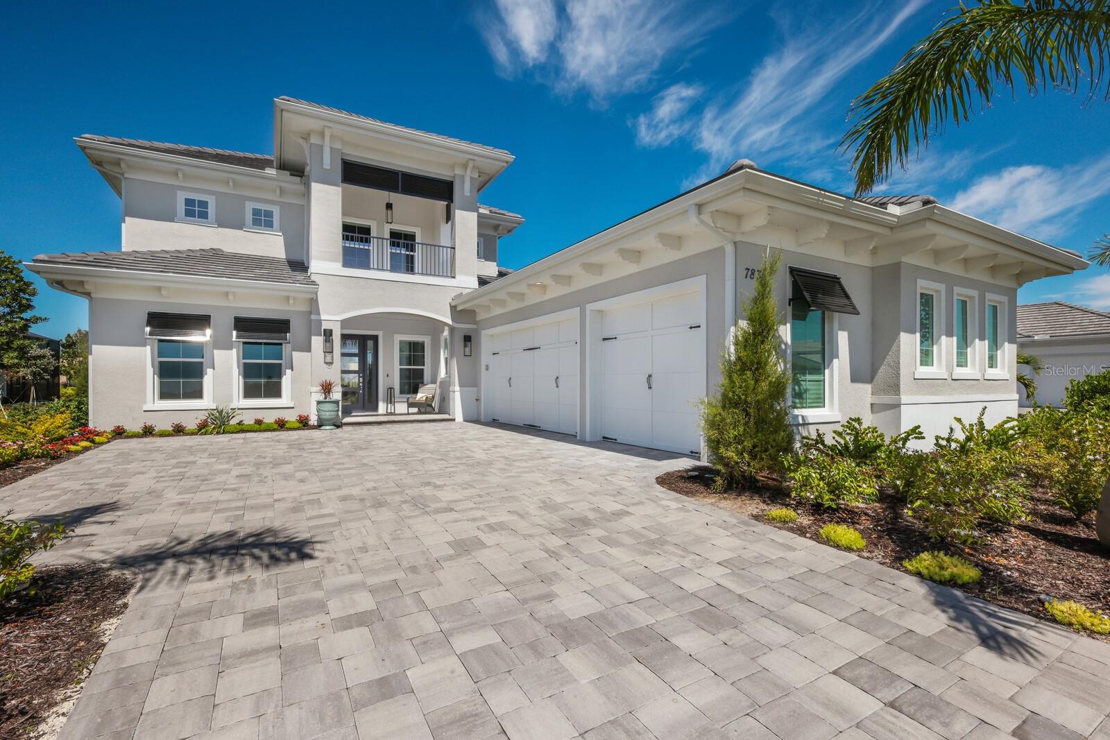 Situated in Lakewood Ranch’s most desirable neighborhood this stunning LAKE CLUB home embodies the true meaning of luxury living. Spectacular TURNKEY FURNISHED, 3702 sq ft 5 bedroom home is practically brand new and only occupied for 8 weeks. Nestled among beautiful lush landscaping on almost one third of an acre, this home offers complete privacy and tranquil preserve views where you can delight in seeing beautiful sandhill cranes. Greeted by a welcoming foyer and captivating views of the outdoor living space, this professionally designed masterpiece is well appointed with today's finest features and a tasteful neutral palette. The Mayfield Grande III floor plan is well crafted, allowing for the ultimate entertaining experience on the first floor and a private retreat for family and guests on the second. The open concept kitchen is the epicenter of the home, where the chef of the family will delight in creating their culinary favorites. Gleaming stone countertops, designer backsplash, gas cooktop, stainless steel appliances, undermount single basin sink and expansive island are some of its most notable features. Thoughtfully designed with entertaining in mind, this home allows for the ultimate in indoor and outdoor living, where disappearing sliding glass doors open to the stunning paver lanai (almost 1500 sq. ft of outdoor living with almost 600 sq. ft of covered lanai) allowing you and your guests to experience swimming and lounging in the salt water pool, unwinding in the heated spa and enjoying the tranquil views through the clearview screen. Whip up an enticing feast with the smoker and rotisserie features and sit back and relax while watching your favorite sports teams. After a full day, retire to the primary suite, a sanctuary tucked away with its own private entrance to the lanai and soaring tray ceilings. The spa inspired en-suite has dual vanities, a seamless glass enclosed shower, standing soaking tub and separate water closet. Guests and family enjoy 4 additional bedrooms, 3 on the main floor with their own en-suite for added privacy and one located on the second floor designed with a private living area and full bath. This flex space is perfect for family visits, your favorite guests, the upstairs retreat has endless possibilities. Look out the second story window and you can see the large lake. Sparing no expense this home also features motorized interior shades throughout offering instant bright or dim lighting with the touch of a button, impact glass doors and windows, engineered wood flooring, designer tile, and outdoor landscape lighting that illuminates the home for evening ambiance. The gated community of Lake Club is one of the most prestigious communities on the West Coast of Florida offering a grand clubhouse for dining, resort style pool, tennis, pickleball, fitness center, dog park and a wide variety of lifestyle activities. A true masterpiece of luxury and refinement, this home is move-in ready, and waiting for you to enjoy the unparalleled lifestyle of Lake Club.