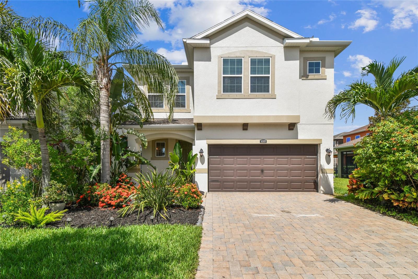 Welcome to 4891 Beeswax Ln., a two-story home nestled in the desirable master-planned community of Bexley in Land O’ Lakes. This 4-bedroom, 2.5-bath home offers tile flooring throughout the first floor and an open-concept layout that seamlessly connects the living, dining, and kitchen areas. The kitchen features a large quartz center island with pendant lighting, stainless steel appliances, a walk-in pantry, and abundant cabinetry—perfect for both daily living and entertaining. Sliding glass doors lead to a spacious, fully fenced backyard. Upstairs, the primary suite includes a private ensuite with dual sink vanity, garden tub, walk-in shower, and an oversized walk-in closet. Three secondary bedrooms share a well-appointed full bath with dual sinks, and the laundry room is conveniently located on the second floor. Residents of Bexley enjoy access to a vibrant lifestyle with resort-style pools, fitness center, miles of trails, playgrounds, dog parks, and a community café. Bexley Elementary and the Bexley Montessori School are both within walking distance to this home. Located just off the Suncoast Parkway, this home is a short drive to Tampa International Airport, medical facilities, shopping, dining, and the Gulf Coast beaches.