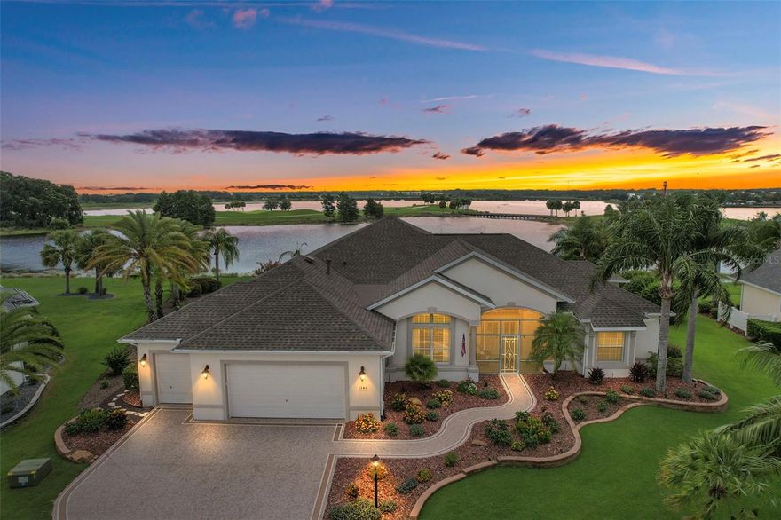 Spectacular WATERFRONT 4 Bed/3.5 Bath FULLY UPDATED CUSTOM PREMIER with POOL and HOT TUB, 2 CAR + GOLF CAR GARAGE in the highly sought after Village of Bridgeport at Lake Sumter. Adjacent to Lake Sumter Landing Market Square and composed exclusively of premier homes, Bridgeport at Lake Sumter is the premier Bridgeport neighborhood in The Villages. This home offers a stunning 74 ft Birdcage, an IN-GROUND SWIMMING POOL with a Power Cover, HOT TUB, and FANTASTIC VIEWS of LAKE SUMTER. Interior features include soaring 12’ ceilings, 8’ doorways, 5” baseboards, high-end QUARTZ countertops, luxury laminate flooring, UPDATED Window Treatments including AUTO SHADES in the Living and Dining Areas! The updated gourmet kitchen offers upgraded cabinets, QUARTZ countertops, Glass tile backsplash, stainless sink, upgraded STAINLESS appliances, refrigerator, GAS cooktop, built-in WALL oven, oversized center island with pendant lighting and Stainless vent hood, ice maker, and a wine fridge. The kitchen is open to the spacious living room with a large 100 inch Sony TV, Hue accent lighting and built in speakers. On the other side of the kitchen is the dining area that is open to the living room and stacking sliding doors to the enclosed lanai. The recently enclosed lanai has tile floors, upgraded Glass sliding doors, Auto Shades, New Electric Grill, 65 inch TV, and is under separate heat/air. This home offers a convenient split bedroom floor plan. The luxurious master suite is off of the Dining area. The large MASTER (15x34) bedroom has a TRAY ceiling, a seating area overlooking Lake Sumter, a dedicated mini split system, an enormous closet with custom organizers, and en suite bathroom with double vanities, large shower, and a soaking tub. On the opposite side of the home, the guest wing is separated from the living room by a pocket door. Bedroom 2 has a double closet, Built in Window seat with storage. Bedroom 3, an additional mini split air system, currently used as an office, has a double closet, Sliding Door to the pool, and its own private bath. The Guest bathroom has a tiled shower and an updated vanity. Bedroom 4 is currently being used as a home gym, but has a Queen Murphy Bed in the closet. A half bath is off the foyer and the 4th Bedroom. The 2 CAR + GOLF CAR GARAGE with storage racks has plenty of room for all of your vehicles and storage needs. Additional features include Reverse Osmosis Water System by Culligan, Black out Shades in the Master and Office, 3 Chandeliers, Newly refinished driveway and walkway, Lightning Rods, 3 Mini Split Ductless units, Security System available. Roof replaced in 2019. AC replaced in 2019. Water heater replaced in 2020. The Village of Bridgeport at Lake Sumter is conveniently located next to Lake Sumter Landing Market Square and only minutes from Arnold Palmer Country Club and Championship Golf Course, Bridgeport Recreation Center and Pool, Lake Miona Regional Recreation Center, numerous executive golf courses, and more. PLEASE WATCH OUR VIDEO OF THIS SPECTACULAR CUSTOM PREMIER HOME!