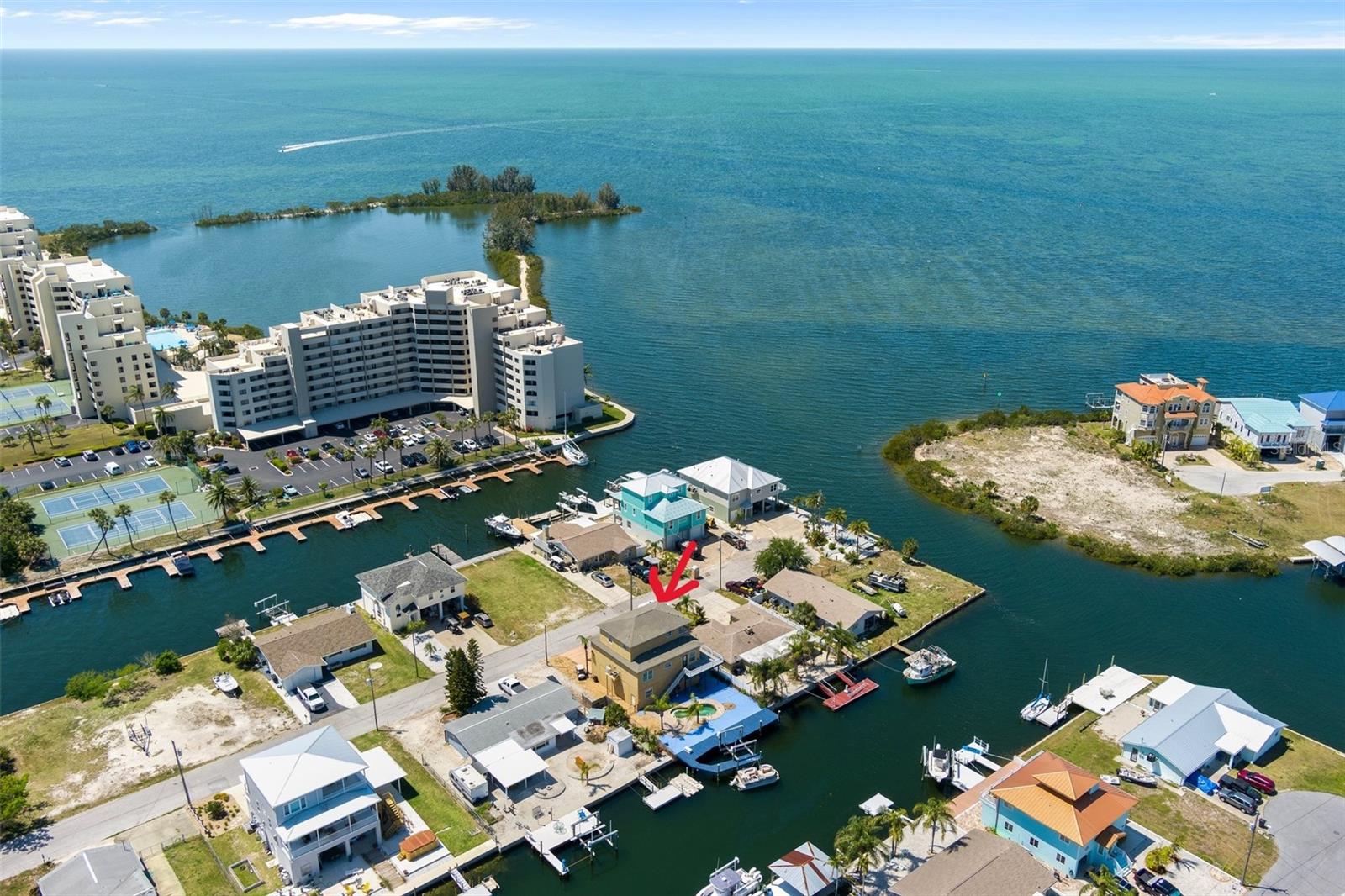 Gulf View Waterfront Pool Home. This 4-bedroom home with elevator, offers spectacular views of the Gulf & sunsets from nearly the entire interior along with a wide and deep canal. Open floor plan with engineered hard wood floorings in the great room and ceramic tile in all wet area. Decorative touches of art niches, pillars and recessed lighting. The kitchen features wood cabinets, granite tops & stainless-steel appliances, with plenty of cabinetry, a pantry & a center island great for preparing meals or entertaining. The spacious master suite also located on the same 2nd floor level, comes with a master bath with his and hers sinks and complete shower and garden tub...3 additional bedrooms and full bath are located on the 3rd level, which offers spectacular views and balcony. Additional features include custom glass leaded front doors, hurricane impact windows & doors throughout...Lower level has plenty of space and can accommodate parking up to 6 vehicles with a workshop area to work on the toys...2180/3868sqft home is situated on the 2nd canal in from the Gulf, providing easy Gulf access to some of the best inshore/offshore fishing in the area! Backyard area offers 60 ft of concrete seawall, heavy duty boatlift, fixed dock and inground pool, perfect for cooling off after a great day of fishing on the Gulf! Not tide limited for most boats and there are No Bridges...Hudson Beach is just a short golfcart or boat ride away and offers great restaurants, entertainment, 4 marinas, boat rentals, charter fishing, public boat ramp and a beach area for swimming. Nearby Sunwest Park with over a mile of Clearwater Beach quality sand, is a beautiful County Park where swimming, wakeboarding, beach volleyball, splash pad can be enjoyed by family and friends. Close to many amenities including, medical services, hospitals, shopping and more. 45 minutes to Tampa International Airport, 2 hrs. to Orlando.