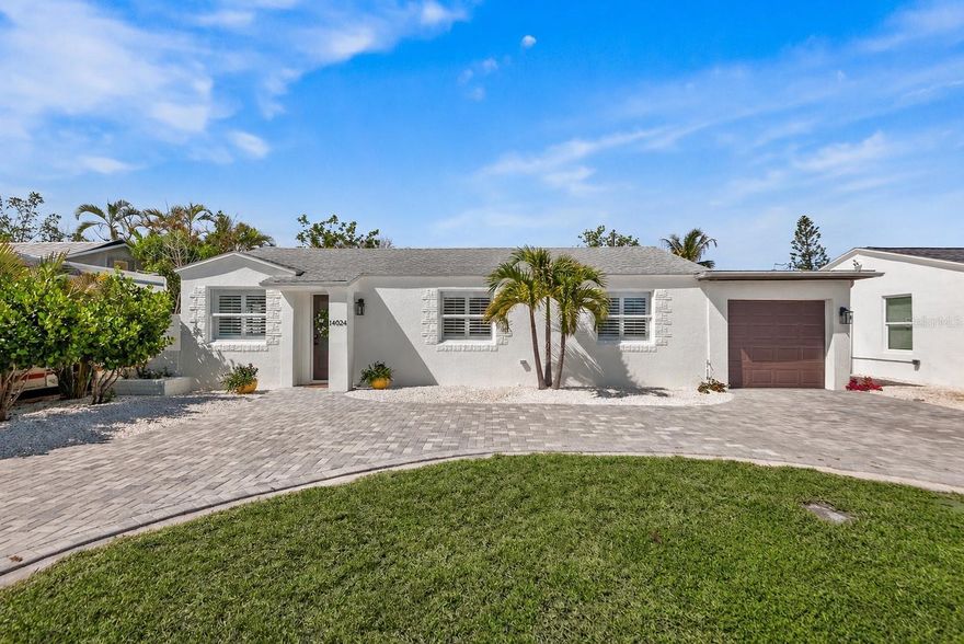 Live where every day feels like a vacation—just three blocks from the bright sugar sands of Madeira Beach and a breezy 5-minute bike ride to the vibrant shops, dining, and waterfront buzz of John's Pass Village & Boardwalk. This stunning, move-in-ready 3-bedroom, 2-bath home has been completely reimagined with high-end upgrades, including NEW hurricane-impact windows and doors, fresh exterior paint, and a striking paver circular driveway. Inside, you’re welcomed by new porcelain tile flooring and a beautifully redesigned kitchen featuring sleek cabinetry, leathered granite countertops, updated lighting, modern backsplash, and brand new appliances. The newly renovated office space with barn doors could also function as a 4th bedroom. Step outside into your own private resort-style retreat. The heated saltwater pool and spa, complete with a cascading waterfall, ambient lighting, and outdoor shower create the perfect setting for both relaxing evenings and unforgettable gatherings. A new expanded paver patio adds effortless style and low-maintenance outdoor living. Every detail has been thoughtfully considered, including custom closet systems throughout and a spacious walk-in closet in the primary suite along with a brand new spa-inspired primary bathroom. The updated garage is perfectly suited for a golf cart, beach gear, and all your coastal essentials, complemented by a new tankless water heater. Framed by fresh landscaping, this home seamlessly blends luxury, comfort, and an unbeatable location—making it an exceptional primary residence, vacation escape, or high-performing investment near the Gulf.