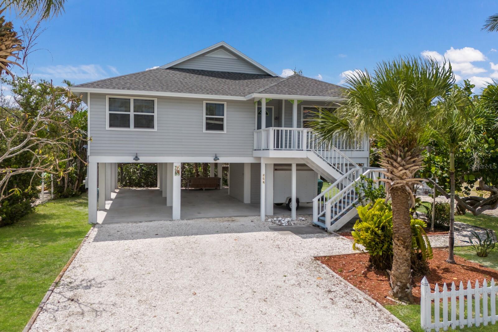 Located on the coveted north end of Anna Maria Island, this elevated canal-front retreat offers a perfect blend of comfort, space, and versatility for full-time living or vacation escapes. This 4BD/2BA home includes a flexible study or den that easily converts to a fourth bedroom, providing room for guests or a private workspace. Inside, the expansive living room features soaring ceilings and sliding glass doors that open to a spacious screened patio, creating a seamless flow between indoor and outdoor living. Open kitchen with walk in laundry/pantry, updated baths and more. Below, generous covered parking and a large storage room ensure there's plenty of room for vehicles and all your island essentials. There is room for a pool and the private dock extends your backyard to the water, offering direct canal access for your water toys. Allowing short stay rentals, this home is not only a tranquil getaway but also an excellent vacation rental opportunity. Combining relaxed island charm with everyday convenience, this property is perfectly positioned to enjoy the best of coastal living. Don’t let this perfect little slice of island life slip away and make it your island escape today!