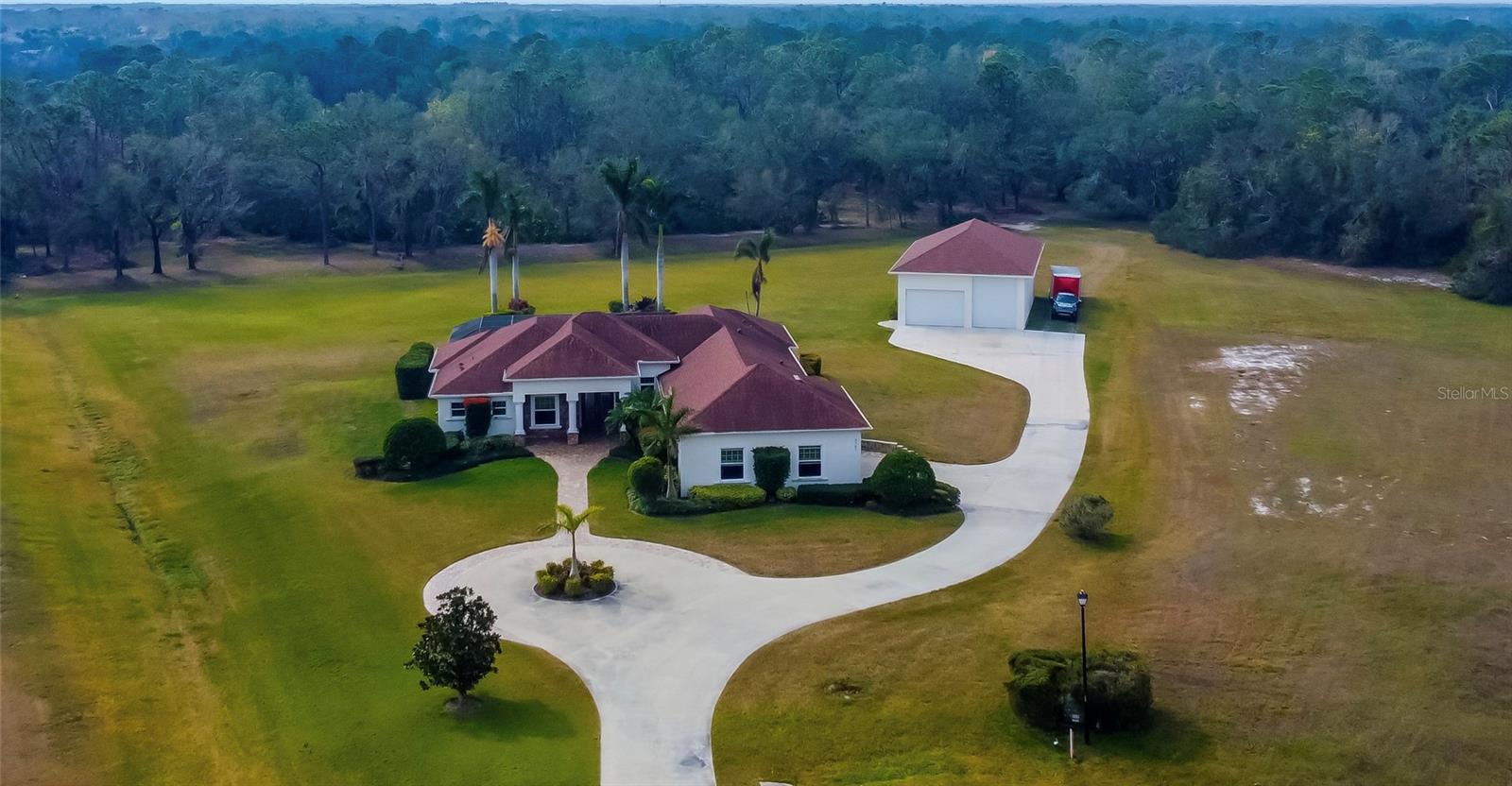 Luxurious 4-Bedroom Pool Home on 5 Acres with an Incredible 2,000 Sq. Ft. Outbuilding!
This custom-built (2014) 4-bedroom, 3-bath home plus office built by Johnson, sits on a premium cul-de-sac lot in Foxbrook, offering ultimate privacy and high, dry land—no damage or flooding from recent hurricanes, even with the eye passing directly over! The house features all impact-resistant windows and sliders, ensuring durability and peace of mind. The attic and walls are fully insulated with spray foam for maximum energy efficiency.
Enjoy a heated saltwater pool, resurfaced in 2023, along with a 3 person hot tub that stays with the home. The outdoor kitchen overlooks a wooded backyard with wide paths and trails, perfect for off-road fun. The property is horse-friendly, surrounded by abundant wildlife, and features a whole-yard irrigation system on well water, while the home runs on city water with a septic tank. The home also includes a new hot water tank installed in 2023.
The Ultimate Setup for Car Enthusiasts & Business Owners! A dream for car collectors, mechanics, or hobbyists, RV or large boat owners, this property features a 2,000 sq. ft. outbuilding with 15-ft ceilings, hurricane windows/doors, full spray-foam insulation, a 5-ton AC unit, and 100-amp power. The oversized 31x30 tandem house garage is designed for maximum functionality, featuring an auto service lift and a 12-ft high door, making it ideal for vehicle storage, large equipment, or workshop space.
Located within the Foxbrook community, residents enjoy amenities such as a basketball court and playground. With its high-and-dry elevation, this rare estate presents endless possibilities—schedule your private showing today!
