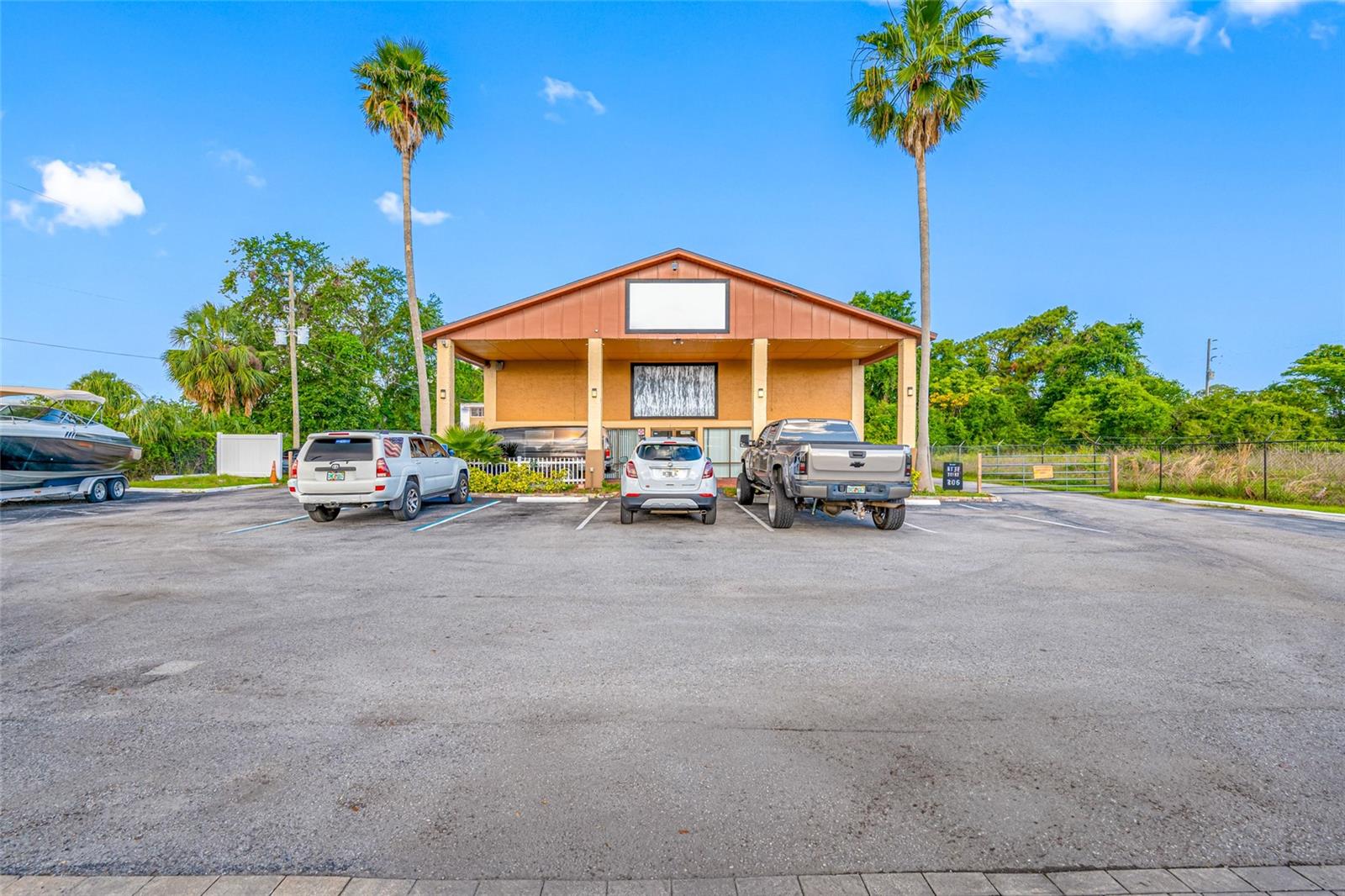 Prime Commercial Opportunity on US Hwy 19 S – Hudson, FL Outstanding visibility and access with frontage on US Highway 19 S, this versatile C-2 zoned commercial property offers 5,500 total square feet (4,750 heated SF) of usable space in a two-story building. Situated on the corner of New York Avenue and US 19, the location provides excellent exposure for signage, customer traffic, and accessibility. The building features a spacious layout with 3 offices, a reception area, waiting lounge, and 2 restrooms on the first floor. Upstairs, you'll find 2 additional offices and another restroom. Several office spaces are large enough to accommodate meetings or serve as conference rooms. A standout feature is the rear high-ceiling, 3-bay garage with both manual and motorized doors. Two bays are accessible via the first floor, with one large, motorized door in the rear for easy equipment or vehicle entry. The garage is accessible from both floors, offering flexible use options. The property includes an asphalt driveway with ample parking for cars, service vehicles, or company signage. Office spaces on both levels are equipped with central heating and air for year-round comfort.
Whether you're looking to operate your own business, expand your current operations, or invest in rental income, this property presents numerous possibilities. A long-term tenant currently occupies the building on a month-to-month lease, generating $3,361 monthly.
Don’t miss this exceptional investment or owner-user opportunity in a high-traffic corridor of Hudson, FL.