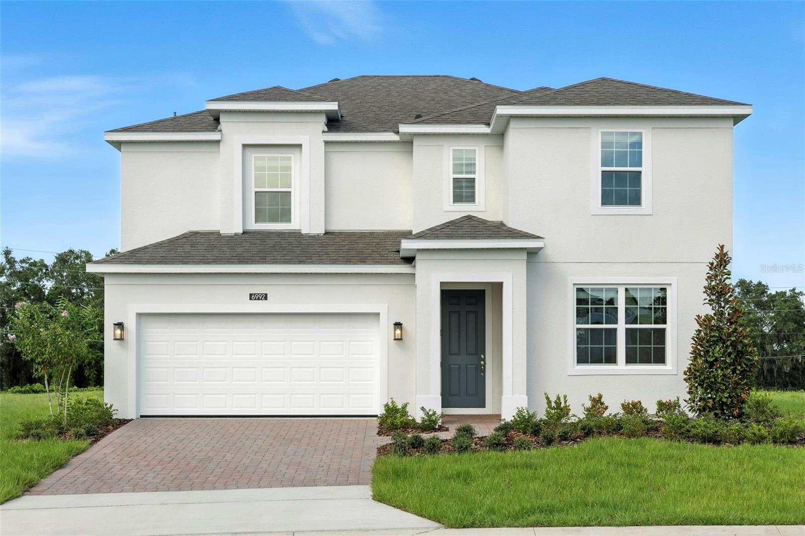 Discover your dream home on the largest homesite in the community with this stunning Newcastle plan, designed with open-concept living and upscale finishes throughout. Boasting 5 bedrooms and 3.5 baths, including a private first-floor guest suite, this home offers both space and flexibility. The expansive 1st floor main living area with 9’4” ceilings, flows seamlessly into a stylish kitchen with 42” cabinets with crown molding, quartz countertops, tile backsplash, and stainless steel appliances. Enjoy indoor-outdoor living with a spacious covered lanai overlooking the backyard, perfect for entertaining. Upstairs, a versatile loft provides extra living space, while the Primary suite features a luxurious bath with dual sinks, a walk-in shower with wall tile surround, and a large walk-in closet. Additional highlights include tile flooring in 1st floor main living areas, a full laundry room with washer and dryer, and charming brick paver driveway and lead walk for lasting curb appeal. Future Community amenities will include Resort-style Pool and shaded Playground. Eagletail Landing is located just south of Lake Harris and near some of the best outdoor recreation in the state as well as Lake County's breathtaking chain of lakes and scenic trails, and a thriving downtown area is just a short drive away, along with 2 nearby championship golf courses designed for a challenging and enjoyable day on the greens.