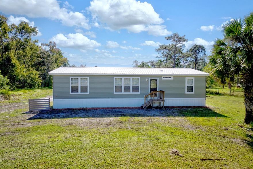 Big, private, and ready for whatever youve got in mind. This 6.38 acre spot in Pinelands, Okeechobee, FL has room to spread out. Built in 2020, the house feels almost new, with a bright, open layout and a roomy kitchen with a center island and tons of cabinets. This place checks a lot of boxes, a big lot for privacy and future plans, an open living area thats easy to live in or entertain, and a primary suite with an en suite bathroom that includes a shower and a soaking tub. Its a two bedroom, two bath home, with convenient access just a couple blocks from Route 441, and the Turnpike under 10 miles away.