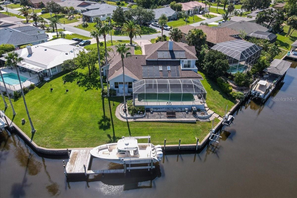 This spectacular custom-built Renik home with tons of upgrades offers over 160 feet on the Cimarron Basin canal with no bridges — true Sailboat Country. The views are breathtaking, and the sunsets… unforgettable.
Recently enhanced with new windows (2024) a large 20,000Lbs boat lift, and a new jet ski lift, this home combines luxury, comfort, and functionality in every detail.Highlights include:Showstopping Italian "Rinkle" wave light centerpiece, Chef’s kitchen featuring a DCS dual fuel range/dynamic cook system, 2-drawer dishwasher, beverage center with Sub-Zero cooler, and Zephyr venting system, 4 bedrooms, each with its own upgraded bath featuring Carrera marble countertops and NEW Japanese "Toto" toilets, The entire upstairs dedicated to the owner’s suite, including a workout room or spacious office for two, and a private walled-in balcony with water views, newer Acacia wood flooring, 2 gas fireplaces, and a sparkling Saltwater pool with Solar heating, Oversized 3-car garage (31x22x10) for all your storage and hobby needs. This home was built for those who want it all — luxury, waterfront living, and every modern convenience.