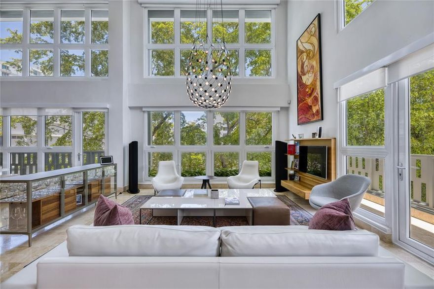 ***SOLD*** Striking 20 ft floor to ceiling glass windows immediately impress all who enter this one of a kind contemporary Penthouse, inclusive of 2,828 sq.ft interior, two flanking north and east terraces, 3 flex 4 beds, 3 baths. A true to form loft, the broad, light infused open spaces of this magnificent Penthouse in the only Loft building in Condado Beach offer sweeping tree canopy vistas, in a two-story residence. Honed marble floors throughout with floor to ceiling glass and city views from all spaces. A modern transitional space, the gourmet kitchen blends polished sophistication with custom Italian cabinetry by Record Cucina, appliances by Gaggenau featuring an induction electric stove top, built-in refrigerator with separate freezer, 3 wine coolers and Bosch double ovens and dishwasher. The family room opens effortlessly from the living and dining spaces, divided by the handcrafted 10ft Italian sliding teak paneled wall by Rimadesio. The first guest suite is just off of the family room on the first floor, facing south with city views throughout, california closet built in living and organization spaces, onsite bath and total privacy. Up-stairs that soar within the tree line in this two story penthouse, the second guest suite features a bay window facing north, and combination office with bedroom amenity in the california closets built in murphy inset. The lofted passageway leads to the primary suite, with open air office facing east down Wilson Avenue, at its landing. Windows flank the southern exposure of this zen space, hosting warm teak tones throughout, ample lounging space and expanded entry into the magnificent ensuite bath. A living wall heralded by swooping tropical orchids and flora hang above the centerpiece inground soak tub. Dual sinks, closets and dressing spaces follow in suit. Technology highlights to this upgraded contemporary space are; 7 zone in wall and app controlled, in-ceiling AC with humidity control by Fujitsu,Unify Whole-house Network system (Cat6) including complete coverage WiFi system with 4 APs. SmartThings Home Automation on Key Electric Circuits plus optional surveillance via 3 static IP Cameras & Door Entry Sensors and 18KW PWRcell Backup Energy Storage (Lithium Ion) by Generac. Function and style are the cornerstones of each living element within the home, highlighted by the craftsmanship and detail throughout. Finished in 2014, 1364 Wilson Avenue is a five story contemporary loft building, including only 12 residences in total and a view inspired shared rooftop terrace, with outdoor dining and lounge space. This Penthouse offers 2 garage parking spaces, electronic key access to the building and a location perfect space. Monthly Condo Fee: $1,000.