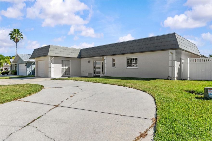 If you want to live in one of the most desirable waterfront communities with coastal waterfront living, this may your HOME!  Here is your completely renovated waterfront retreat featuring four bedrooms and three full bathrooms just under 2000 square feet of thoughtfully designed living space. This stunning home showcases luxury vinyl plank flooring throughout, hurricane-rated impact windows and sliding doors, and a brand new roof installed in 2025.  This beauty has 2 bedrooms that have their own bathrooms. Perfect for guests.

The heart of the home features a completely rebuilt kitchen with new appliances including dishwasher, oven, and refrigerator. All three bathrooms have been beautifully renovated with new vanities, granite countertops, comfort-height toilets, and modern fixtures. The primary bathroom boasts updated flooring, mirror, and vanity, while the third bathroom includes a bidet and electric towel rail.

Step outside to discover exceptional outdoor living spaces. There's a screened lanai that features all NEW screens and polyspartic coating, while the back patio received a premium $10,000 coating treatment in 2024. A NEW PAVER FIRE PIT with new paver walkways create the perfect gathering area. This yard is completely FENCED in!  The RESURFACED Salt Water pool is a great space for entertaining with a spacious covered patio area overlooking the canal to the Gulf of America! The hurricane-rated garage features polyspartic coating and overhead door.

Boating enthusiasts will appreciate the floating dock and 10,000-pound automatic boat lift installed in 2021, complete with fish cleaning station and floating dock and outdoor shower.  Just lower your BOAT on your private boat lift and go see the beautiful manatees, sea turtles, DOLPHINS and lots of birds!  Take your boat to the close by waterfront restaurants, sand bars and islands. 

Additional upgrades include newer HVAC system, All interior Paint, exterior stucco work and painting, plus comprehensive renovations completed between 2019-2025. The list goes on and on!  The community offers organized activities including beach volleyball, corn hole tournaments, yoga, and themed parties. The neighborhood offers a PRIVATE BEACH in the neighborhood for a only $200 year to watch the sunsets every night!  You can have a picnic under the Pavilions and grille burgers & hotdogs with the provided grilles.  Residents enjoy access to nearby Robert K Rees Memorial Park, convenient shopping at Publix, and quality education options at WonderED K12 Academy.  Golf Cart Friendly and minutes away from Downtown New Port Richey with lots of shopping and restaurants.  Minutes away from Tarpon Springs and the sponge docks.  A short 15 minute boat ride to the Anaclote Island and sandbar!  Just 2 Canals over then you are on the open GULF of AMERICA!  This neighborhood is golf cart friendly!  If you love boating, fishing and COASTAL LIVING then this is your dream home!