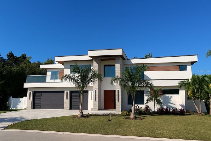 This newly built modern residence offers 3,950 sq ft of refined living space in the highly desirable area, just minutes from Downtown Sarasota, Sarasota Memorial Hospital, and Arlington Park’s recreational facilities. Designed and crafted by European architects, this home stands out for its elevated finishes, integrated storage solutions, and exceptional attention to detail.

The home features four bedrooms, five bathrooms, an office, a gym/flex room, and a second-floor lounge with a glass catwalk overlooking the main living area. What sets this home apart from others, every room includes custom built cabinetry and storage, including sleek wall systems and fully built-out walk-in closets with glass fronts and LED lighting. These built-ins are architectural elements, giving the home a clean, modern, move-in-ready feel. 
A premium built-in central vacuum system with “Hide-A-Hose” technology adds comfort and efficiency to everyday living. The retractable hose design eliminates the need to carry or store bulky vacuum equipment.

The main kitchen is designed with premium European cabinetry and equipped with high-end Fulgor Milano appliances. An oversized island and open layout create an ideal space for both everyday use and entertaining.

The outdoor area is a private oasis with a modern heated pool, infinity spa and shower area, and a beautifully designed outdoor kitchen. The property also includes a rare, oversized three-car garage, offering exceptional storage and flexibility.

Additional features include tall ceilings, abundant natural light, integrated lighting throughout, a modern open-concept layout, and precision workmanship seen in every part of the home. 

Located in one of Sarasota’s most central and desirable areas, you are minutes from downtown, shopping, restaurants, parks, and the hospital.

This is a unique opportunity to own a modern European home with features rarely available in Sarasota. Schedule your private showing—this home will not last.