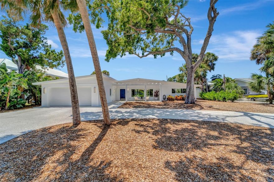 Welcome to your spacious Siesta Key canal front home in the highly sought-after Sara Sands neighborhood. From the moment you enter this professionally remodeled mid-century modern beach retreat, you will enjoy sweeping water views of the salt water pool at the top of a T canal. Two large clerestory windows, a wall of sliders, 12 ft cathedral ceilings and 3 skylights fill this home with an abundance of light. A much desired split floor plan includes 3 large bedrooms and 3 full bathrooms, 2 of which are en-suite. The master suite and adjoining sitting room/ office open with sliders to the newer salt water pool and expansive deck. The low maintenance yard leaves plenty of time for swimming, grilling, fishing and boating, with a dock and only one fixed 15 ft high bridge to the Bay and Intracoastal Waterway, direct to the Gulf of Mexico. Hurricane protection throughout. Recent updates which include among others, a newer sea wall with an extra wide cap, air conditioner, kitchen appliances, pergola, front porch, garage, and extra-wide circular driveway, make this home move-in ready. Nestled on a quiet dead end street, yet only a short walk to the North Village of Siesta Key, #1 quartz sand beach in the USA, bars, restaurants and shops….your serene tropical paradise awaits!