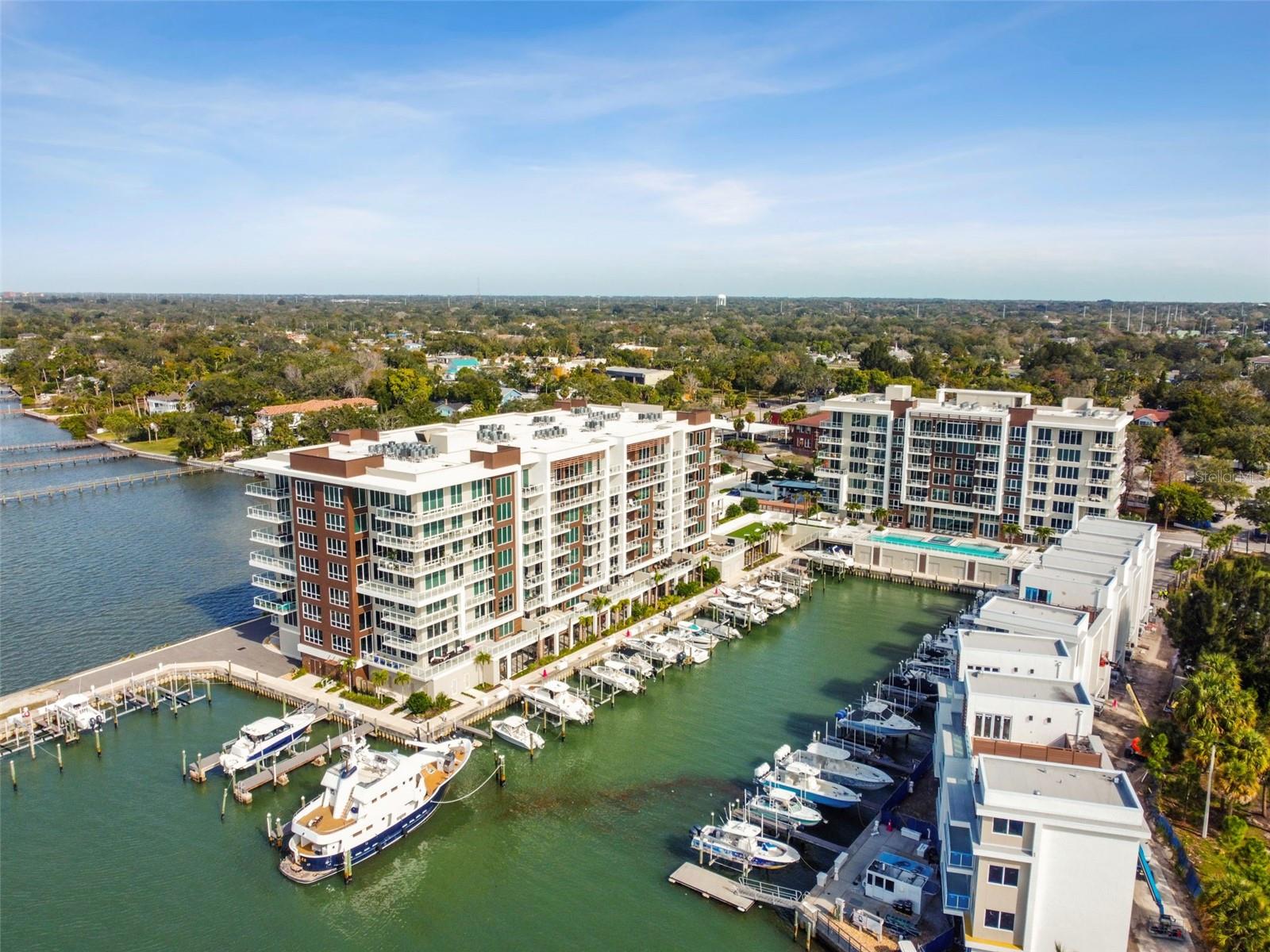One or more photo(s) has been virtually staged. Welcome to your new home in the beautiful Marina Bay community! Marina Bay will surpass all your expectations - From personalized concierge services to perfectly manicured amenities, every detail was carefully curated to bring resort style living to its residents. Immerse yourself in a serene pool overlooking the water, and rejuvenate in spaces like the state of the art fitness center, jacuzzi or steam room. Enjoy putt-putt by the pool, bask in the sun on the outdoor lawn, or snuggle up by the fire pit - just a few of the perks this community offers. Residence #304 is a 2 bedroom, 2 bathroom unit with a versatile den space perfect for a home office, and spacious private terrace overlooking the water. The open floor plan and sprawling windows breathe ample light into this home. Triple track living room sliding doors open up the living space to seamlessly blend with the oversized outdoor terrace. Upgraded tile flooring gives this unit a sleek and luxurious design. Enjoy the Master Suite with his & hers closets, and a spa like bathroom adorned with double vanity and a large walk-in double shower. Find your culinary dream with this beautiful light and bright kitchen - its well-designed layout, stainless steel CAFE appliances, and sprawling island counter space creates an ideal environment for culinary enthusiasts. Master Bedroom, Guest Bedroom and Living Room all enjoy direct access out to the spacious terrace overlooking the water.