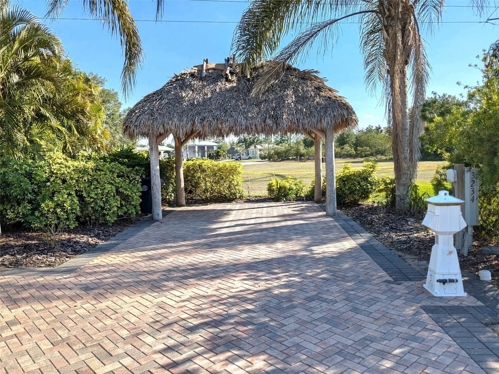This premium paved RV lot with a Tiki Hut in Bay Lake Motorcoach Resort is a rare opportunity for investors, snowbirds, or full-time RVers seeking the ideal Florida lifestyle. Located in a secure 55+ luxury community in Polk City, this lot offers low-maintenance living with high rental potential. The beautifully re-thatched Tiki Hut adds tropical charm and functionality, perfect for entertaining or enjoying quiet, shaded relaxation. Bay Lake is a Class A motorcoach resort with resort-style amenities including a 12,000 sq. ft. clubhouse, heated pool and spa, fitness center, billiards, craft and media rooms, a private movie theater, and direct access to Lake Mattie with fishing and a private boat launch. Conveniently situated between Orlando and Tampa, you're minutes from world-famous theme parks and within easy reach of both Gulf and Atlantic beaches. Whether you're looking for your own seasonal retreat, a full-time residence, or an investment property, this lot checks every box. Schedule your tour TODAY!