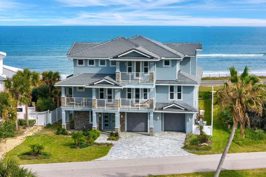 Where modern design meets the magic of coastal living, this newly built Flagler Beach oceanview estate redefines life by the shore. Imagine waking each morning to the sound of waves and panoramic views of the Atlantic and Intracoastal, framed by five private balconies capturing every sunrise and sunset. Step inside and discover 6,200+ square feet of contemporary luxury open-concept living spaces, floor-to-ceiling windows, and architectural fireplaces that blend warmth with sophistication. The chef’s kitchen is pure artistry: a waterfall island, custom cabinetry, and designer finishes ideal for gatherings, entertaining, and everyday indulgence. An in-home elevator connects all three levels, leading to serene bedrooms and a private primary suite where mornings unfold with ocean views and nights drift away under starlit skies. Outdoors, lush tropical landscaping, deep-well irrigation, and a private beach walkover create your own seaside sanctuary. With a four-car garage, energy-efficient construction, and luxury details at every turn, this home captures the essence of Florida coastal living  elevated, effortless, and unforgettable.