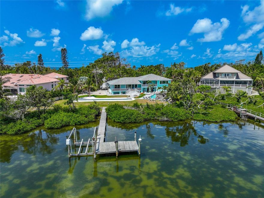 One or more photo(s) has been virtually staged. This extraordinary island property offers a rare opportunity to own a piece of paradise in one of Florida's most sought-after coastal destinations. Nestled on a pristine stretch of Manasota Key, this private estate boasts unparalleled panoramic views of Lemon Bay. From the comfort of your deck, or sitting on the dock, indulge in the captivating water vistas that stretch as far as the eye can see. Ready to hit the beach? Conveniently located just a short distance across the street is a deeded beach access allowing you to enjoy the white sand beaches and tranquil waves at your leisure.
The exterior of this beautiful island home is a testament to life on a Florida key. The landscaped gardens and mature trees are illuminated to complement the property. The outdoor oasis has a heated swimming pool featuring a grotto, fire accents, and a soothing waterfall. The backyard amenities continue to impress with an outdoor shower, shuffleboard court, a white sandy play area, and a cozy fire pit. You'll have endless opportunities for outdoor enjoyment and entertainment.
The private dock sits in front of an approx. 88ft wide sea wall offering easy access for your boat, kayaks, and paddleboards! It extends about 300ft directly into Lemon Bay. The water depth at low tide is approx. 4ft deep and there is ample space to tie off. The dock is also in the process of getting a brand new Creative Marine lift that will hold a 10,000 lb boat lift, water, and electricity.
The interior underwent a complete remodel in 2020, showcasing elegance and top-notch craftsmanship. The large chef's kitchen and dining room with views of Lemon Bay is an entertainer's dream. This space is great for gathering friends together to create your culinary masterpieces, the kitchen features a large, granite topped island, stainless steel appliances and a walk-in pantry. 
With 3 bedrooms, 3.5 bathrooms, indoor and outdoor living space, this home offers an extraordinary amount of space for entertainment and relaxation. In addition to the bedrooms, a bonus room is currently set up as a theater room, complete with programmable remote blinds, surround sound, and acoustics. Enjoy an immersive cinematic experience within the comfort of your own home.
The primary suite is a haven of luxury, featuring a private balcony overlooking Lemon Bay. Escape to this bedroom retreat to unwind and embrace the beauty of your surroundings. The spacious primary bedroom boasts intricate details, including backlit pre-lit onyx countertops with a drink fridge, heated bathroom floors, jetted spa-tub, walk-in shower with a rain showerhead and four body shower heads, plus dual vanities. The primary suite also offers a large walk-in closet with custom shelving system and an additional closet for ultimate convenience.
This residence is equipped with wireless, Bluetooth connected devices. Control the waterfall, pyro flames atop the waterfall, surround sound speakers inside and outside, lighting, security system, blinds, and more with ease.
This is a once-in-a-lifetime opportunity to embrace coastal living at its finest. Immerse yourself in the serenity of this extraordinary property, where every detail has been carefully curated to provide an unparalleled living experience. Enjoy the breathtaking views, indulge in outdoor recreation, and savor the luxurious comforts of this exquisite waterfront retreat. Take the opportunity to watch the video and use the 3D tour feature for this home right now.
