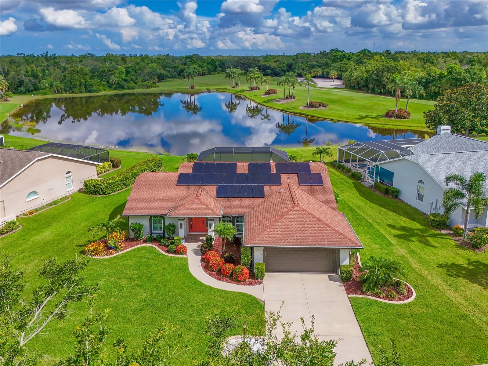 There's no place like home...in this picture-perfect updated pool home. It's hard to find the exact words to describe this one of a kind home; Pristine, peaceful, picturesque, charming, flawless, captivating, or perfect condition? You need to come see for yourself the spectacular lot that sits on the edge of a lake and the 16th signature hole of Tara Golf and Country Club. Open floor plan as you enter the living area with vaulted ceilings, triple sliders that pocket open to the lanai surrounded by lake and golf course vistas. Dining room sparkles with unique lighting and large arched windows for all the natural light you want in your Florida home. Three bedroom are in a split floor plan. One of the bedrooms is presently being used as a den. Plantation shutters in the bedrooms. Kitchen has stone counters, new appliances, Bosch dishwasher, LG Refrigerator and stove, breakfast bar, 48 inch cabinets and a cozy eating area with views of the lake. Primary bedroom has vaulted ceilings, walk-in closets, en suite fully remodeled bath with walk in shower and soaking tub. Meticulously maintained home has impact hurricane windows, automatic roll down hurricane drop downs on lanai and front door. New front door and side lights were installed in 2024. Owner owned Whole house solar panels power the home and results in a monthly electric bill of $26.35. Freshly painted inside and out. All new lighting. Tile floors though-out the living area, luxury vinyl plank flooring in the primary bedroom and second bedroom. Spend endless days enjoying your water views from your oversized lanai with newer picture screen bronze cage, Traver Stone decking, resurfaced Pebble Tec pool and brand new pool heater. If you need to ever leave this oasis, you can enjoy your Class A membership to TGCC. It is a private, bundled golf community that includes Tennis, Community Pool and spa, Bocce, Full Fitness center, New Pickle Ball facility (to be opened Sept 2025) Clubhouse dining and activities (clubhouse to be completely remodeled 2025-2026 ) 18 hole championship golf course, renovated in 2023. No assessments to the members and no CDDs. Welcome to Taradise!