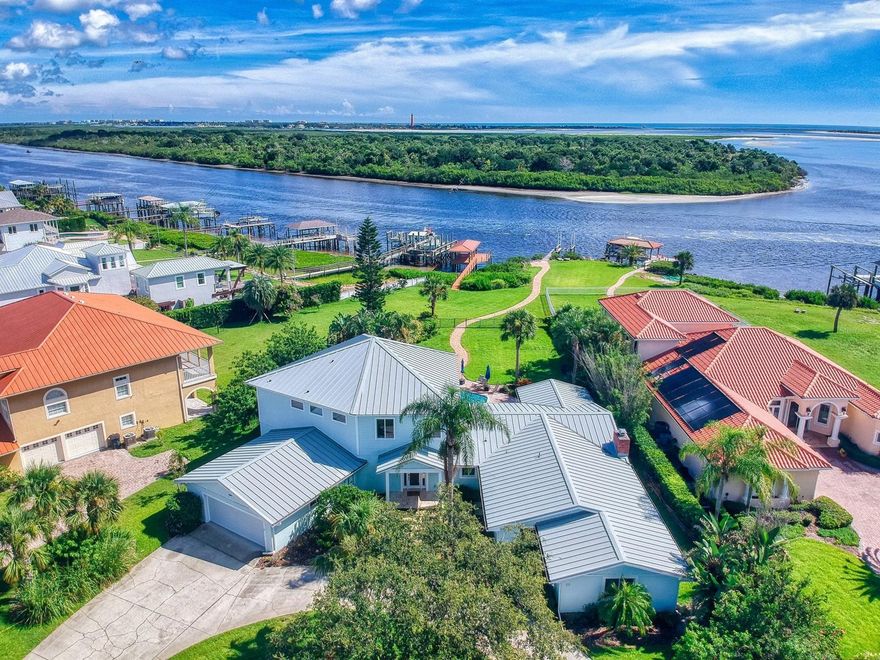 Welcome to your riverfront dream estate with this stunning 4 bedroom, 3 bath, pool home that includes your own boat dock and lift! Boasting 5100 square feet of living space this flexible floor plan is perfect for a growing family, a large family or family with in-laws.

The north side of the home features a gorgeous, custom kitchen w large island and double ovens. Gather your family together for family meals in the large formal dining room. The spacious living room features, Travertine Tile and sliders that open to the  
inviting pool deck. Enjoy the second floor, main bedroom and bath retreat with its huge private living room and balcony with stunning views of the river.

The south side of the home features, 3 bedrooms, 2 baths and another large kitchen w double ovens. It also offers another spacious family gathering room with a wood burning fireplace, in addition to a large 20 x 15 flex space.

Additional home features are, Plantation Shutters, 3 A/C units, 2 water heaters, Metal roof, Hurricane shutters, 2 laundry rooms, a fenced yard, a separate entry and 2 car garage.

Imagine hosting unforgettable pool parties and making a splash in your private pool overlooking the river.  Stroll down to your dock with boat lift and embark on your boating journey. With the Intracoastal Waterway in your back yard you are just minutes to Disappearing Island, the Inlet or your fishing adventures. 

Don't miss this chance to experience this ultimate waterfront oasis in New Smyrana Beach - seize the day and make this your forever home! ;Water: City