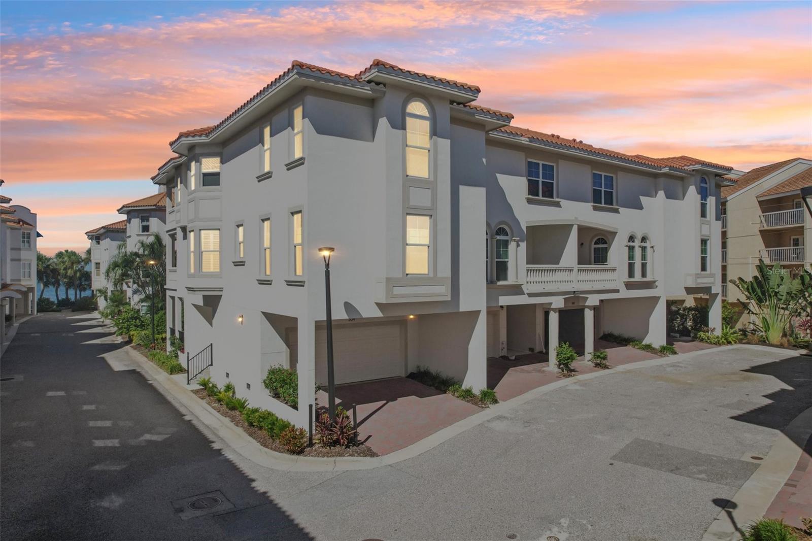 Experience modern coastal luxury in this stunning, FIRST TIME ON THE MARKET, 2023 townhouse in gated San Ruffino. This 3 bedroom, 3 bath, 2 car garage located in the heart of charming Dunedin was UNTOUCHED by 2024 Hurricanes and has been impeccably maintained by the original owner. This is upscale Florida living at its finest, every detail in this beautifully crafted residence speaks of elegance and style—from the warm gray designer palette to the luxury vinyl flooring that flows seamlessly throughout the home. As well as practical considerations like the elevator servicing from the 1st floor to the 3rd and expansive hurricane-rated windows and doors that are dressed with Hunter Douglas blinds, Plantation Shutters and custom Linen Drapes, offering both sophistication and privacy. The first floor is the garage, large deck to lounge and wave to your friendly neighbors and room for storage. Up to the second floor you'll find a bedroom and full bath, the living area and of course the fabulous kitchen. The gourmet kitchen is a true showpiece, boasting all High-End Fulgor Milano appliances, range is INDUCTION and CONVECTION, fabulous glowing quartz countertops complemented by a unique shimmery shell tile backsplash that adds that coastal flair. The top floor is where you will find the remaining guest bedroom and full bath as well as the Grand Primary bedroom that is spacious yet intimate with a WALK IN closet large enough to house your treasures and flowing into the stunning Spa-like bathroom with modern standing tub, dual vanities and oversized shower with floor to ceiling Carrera tile. Entertain in style or unwind in comfort with spacious living areas bathed in natural light. Or on three decks with WATER VIEWS. As well as the community POOL set ON THE WATER with PANORAMIC views of St. Joseph sound where you can relax and observe local wildlife like dolphins, manatees, flying fish, Pelicans, Osprey and so much more! This home is not just a place to live—it's a lifestyle. Ideally situated just minutes from downtown Dunedin’s vibrant shops, restaurants, and waterfront, and a short drive to Honeymoon Beach Park and Ferry to Caladesi Island, as well as half an hour from Tampa international. FLOOD INSURANCE NOT REQUIRED except lender may mandate a minor policy.