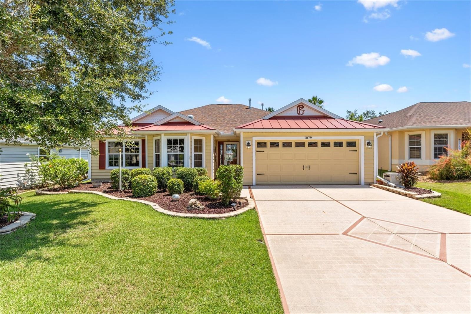 BOND PAID! ROOF (2023), HVAC (2022) — Whispering Pine model (NO WALL IN THE LIVING AREA) in The Village of CAROLINE! Just 1 MILE TO LAKE SUMTER LANDING. PARTIALLY FURNISHED and GOLF CART INCLUDED. This AMAZING home features TROPICAL LANDSCAPING that provides ULTIMATE PRIVACY.
Step through the GLASS FRONT ENTRY DOOR into the well-lit, generous foyer of this METICULOUSLY MAINTAINED home! The OPEN CONCEPT living and dining rooms feature FABULOUS VINYL PLANK FLOORING and HIGH VAULTED, SMOOTH-TEXTURED CEILINGS, creating a SPACIOUS AND AIRY main living area.
The AMAZING kitchen boasts GORGEOUS WHITE CABINETRY, GRANITE COUNTERTOPS, GRANITE BACKSPLASH, STAINLESS STEEL APPLIANCES, and an EAT-IN BREAKFAST BAR. An adjacent dinette features VAULTED CEILINGS and a beautiful BAY WINDOW, allowing for ABUNDANT NATURAL LIGHT.
From the living room, step through the sliding glass doors into the INCREDIBLE ENCLOSED LANAI, adding 220 SQUARE FEET OF COOLED LIVING SPACE — perfect for entertaining guests, bunco/card night, or a quiet cup of coffee in the morning. PRIVACY LANDSCAPING AND HEDGING surround this wonderful space. Just outside the lanai, you’ll find a GENEROUS-SIZED POURED CONCRETE PATIO — ideal for soaking up the sun or BBQs.
Back inside, the LUXURIOUS PRIMARY BEDROOM boasts a HIGH VAULTED CEILING, CROWN MOLDING, and a LARGE WALK-IN CLOSET. The en-suite bathroom features WHITE CABINETRY, DOUBLE VANITIES, and a STONE WALK-IN SHOWER.
A second bedroom and bathroom are conveniently located near the front of the home, creating a PRIVATE GUEST WING. The second bathroom includes GORGEOUS GRANITE COUNTERTOPS, a TILED TUB/SHOWER COMBINATION, and a HALLWAY LINEN CLOSET.
The third bedroom (no closet) features VINYL PLANK FLOORING and a LARGE BAY WINDOW, making it a perfect home office, den, or an additional sleeping area for guests.
The GENEROUS TWO-CAR GARAGE offers plenty of space, a LAUNDRY AREA with extra cabinetry, a MOTORIZED GARAGE DOOR SCREEN, and ample room for parking and storage.
The Village of Caroline is just minutes from Lake Sumter Landing and CR 466, with an abundance of shops, restaurants, banks, medical offices, and more!
PLEASE WATCH OUR WALKTHROUGH VIDEO of this STUNNING HOME, and call today to schedule your Private Showing or Virtual Tour!