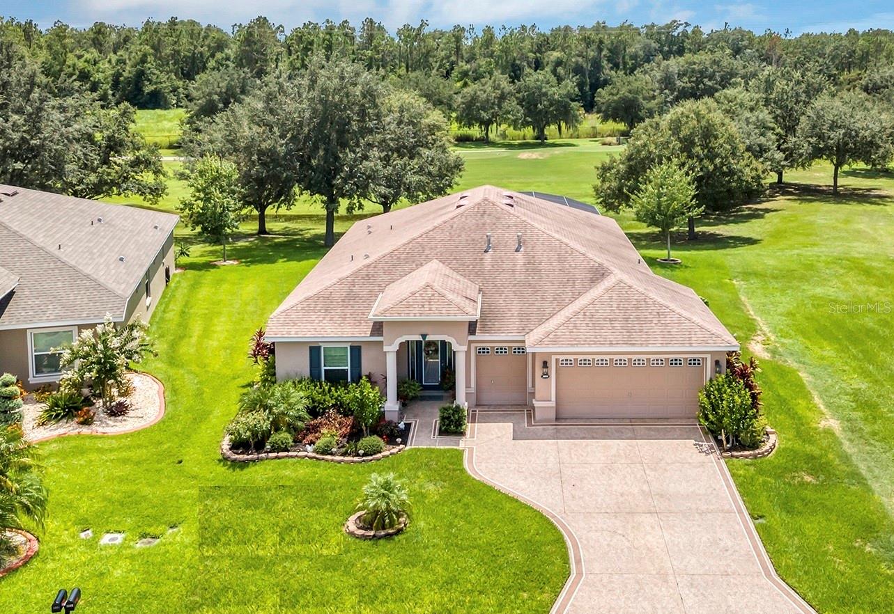 SPRING HAS SPRUNG, FALL HAS FELL, SUMMER IS HERE AND IT'S HOT ENOUGH TO BUY A POOL HOME. Affordable Golf-Front, Pool Home living in a Guard Gated Active Adult Golf Community. Discover a lifestyle of comfort and leisure you've waited for your whole life for in this charming golf-front, pool home located in the popular, high-demand Arlington Ridge Guard Gated Golf Community With a low HOA of $124 per month, Built in 2018, this 3 bedroom 2 bath 2,001 square foot home with 2 Car + Golf Cart Garages. Calla Model with Vanda Island, Home boasts modern design and low-maintenance stucco construction, open-concept floor plan and 9 foot ceilings enhance the sense of space and inviting atmosphere and overlooks the golf course. This modern design has rounded corners on sheetrock, all hard low-maintenance flooring consisting of NO CARPET only tile and BRAND NEW! luxury vinyl plank flooring throughout the home. Kitchen is open to great room w/ high ceiling & crown molding and dining room are perfect for entertaining and features ample wood cabinetry, granite counters, Large Vanda style bowed island with bar-top and abundant natural light. The range and fridge are included. The master bedroom offers trayed ceiling a scenic view of the golf course and features an en-suite bath with dual vanities w/ granite tops, a walk-in Roman shower, walk-in closet, and a private water toilet closet. A 900+ s.f. screened lanai and hard to find private lot overlooking the golf course are perfect for entertaining or simply relaxing with room to add a year round outdoor kitchen. Watch your spouse and friends golf while enjoying your favorite drink. The backyard is private, no golfers in your backyard If you're looking for paradise, You've found it. Home pre-wire for whole-house generator. Benefit from huge discounts on homeowner's insurance due to the home's high construction standards being built to wind code, high elevation for flood protection, and a low wind zone, also qualifying for additional insurance discounts. The low HOA of $124/month includes, Wi-Fi router for signal coverage throughout the home, 200+ cable TV channels, and 250-megabyte high-speed internet. Two DVRs are also included for recording your favorite shows which is all included in the low HOA of $124/month making this community even more affordable than nearby communities This sought-after community offers a range of amenities, including an 18-hole golf course where you can get a tee time year round, driving range, putting greens, lighted tennis and pickleball courts, 2 heated swimming pools, hot tub, fitness facilities, billiards, a restaurant, tavern, and a free movie theater. The community is golf cart-friendly, with sidewalks for strolls and low-speed limit streets perfect for bicycling. Enjoy the convenience to grocery stores, restaurants, banks, and pharmacies within a 5-minute drive. Emergency services are just 10 minutes away, and a free boat ramp and fishing pier on a 15,000-acre lake Harris 50,000 acre chain of lakes (Major Bass fishing & tournament destination are nearby. Community is 20 minutes from malls, restaurants, and a 12-screen movie theater, 45 minutes from Orlando, Major theme parks, and the airport, 90 minutes to Daytona Beach & Atlantic Ocean and Gulf of Mexico Clearwater SJS 2024©