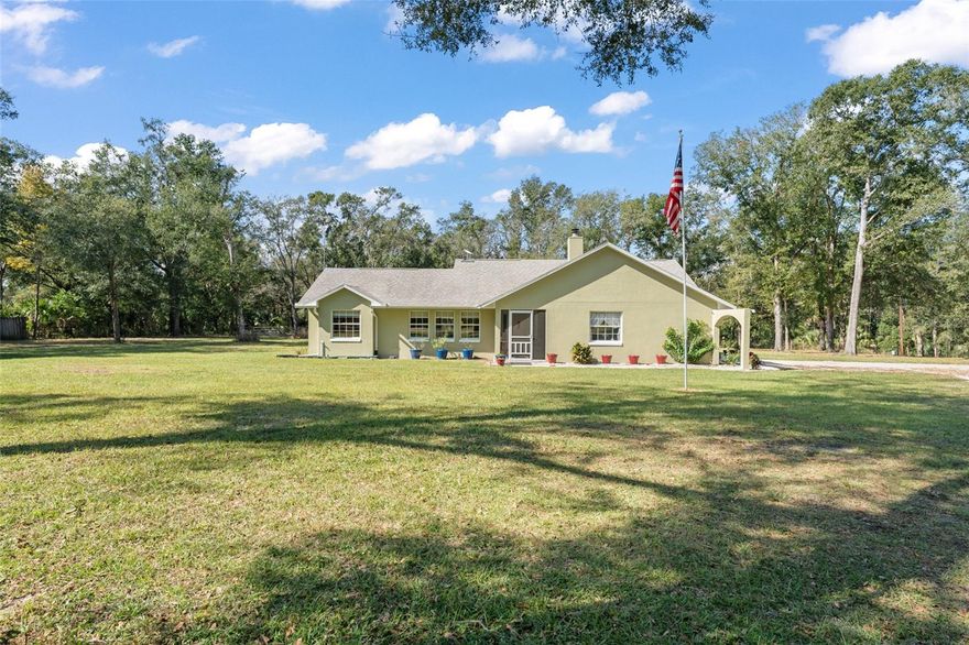 Bring your RV, Boats, Horses, Animals, ATVs and MORE!  This incredible split floorplan home will provide everything you need to create an amazing life on close to 4.5 beautiful acres.  METICULOUSLY MAINTAINED, beautiful POOL home with over $70,000 in upgrades in the last two years alone:  Front Load Washer (replaced 2023)+Water Softener and Sulfa Water Filtration (10/2023)+ Wifi Thermostat (10/2023)+ Dishwasher (11/2023)+ Pool Resurface (4/2024)+ Variable Speed Pool Pump (4/2024)+Upgraded Electric Service to 200 amps (4/2024) + Gutters added to front and sides of the house (4/2024)+ Quartz Kitchen and Primary Bath Countertops and Sinks(10/2024) + Garbage Disposal (10/2024)+Replaced wire fence and poles (2025)+ Exterior and Interior paint (2024) + Flag Pole (6/2024).  Enjoy the OVERSIZED 3-Bay DETACHED WORKSHOP/GARAGE with rollup doors and 220V for equipment. PLUS an additional 24 x 32 metal BARN for HORSES or storage and additional smaller storage shed! Additional upgrades: Updated Sliding Doors+Fireplace+ ROOF (2015)+WATER HEATER (2023)+ WELL pump (2014) & Tank (2023)+ roll-out poolside awning +POOL SWEEP (2023) + Updated Accessible Spare Bath, and COVERED RV PARKING. The Updated Fixtures include Upgraded SS GE Profile DOUBLE OVEN and the Stainless Steel Refrigerator.  BRING THE HORSES with nearby trails and space to store your boats, ATVs and more!  There is a BONUS plot across the way for your Garden, GAZEBO or Greenhouse!! Convenient to the 429 CORRIDOR to ORLANDO ATTRACTIONS, Chain of Lakes, Ocala National Forest, Pristine LAKE NORRIS Conservation Area and charming Mount Dora. Come and see all this amazing home has to offer!
