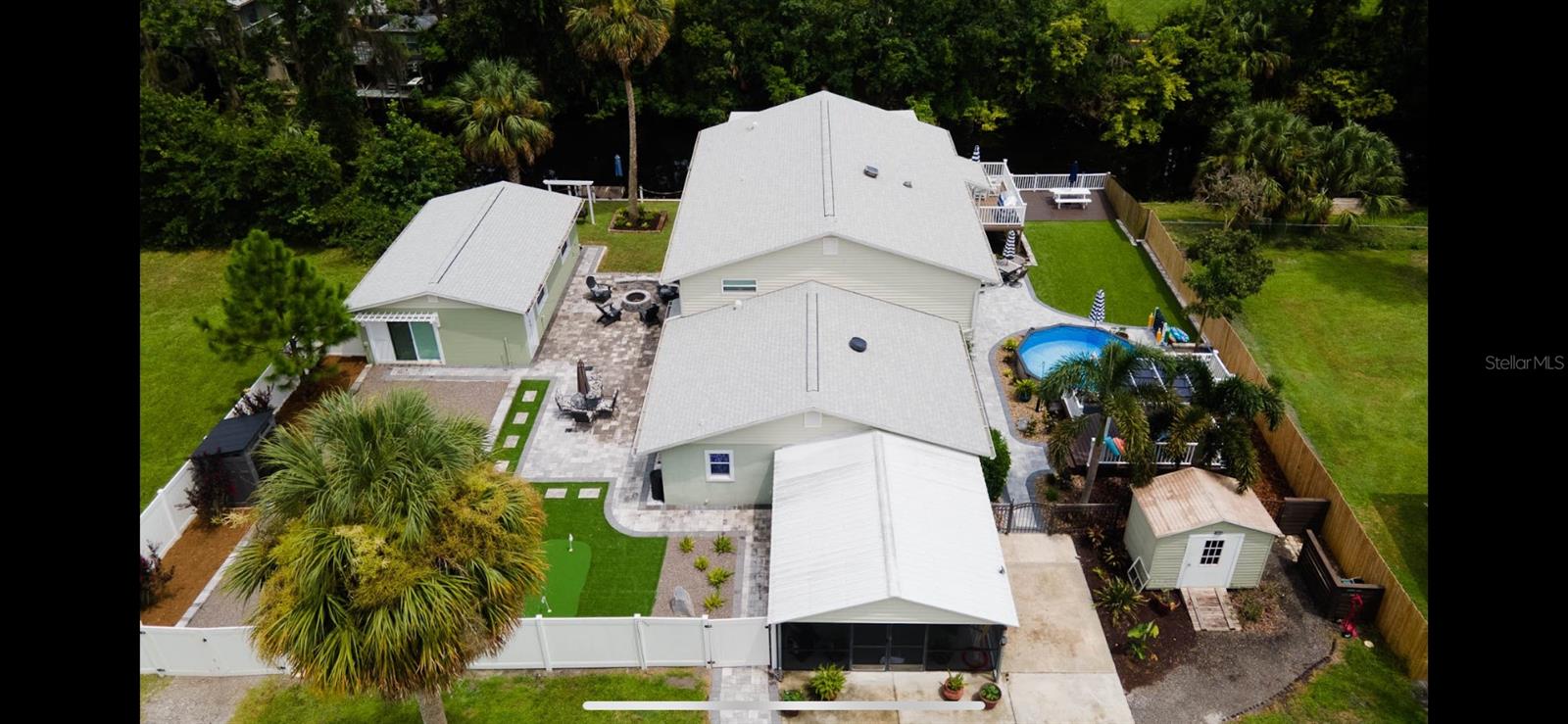 Ultimate Multigenerational Waterfront Home – St. John’s River Access Home uniquely features a detached 1/1 apartment with full kitchen and laundry, plus a ground-floor handicap-accessible suite with its own kitchen, bath, and laundry. Upstairs, the main home offers 3 bedrooms, 2 baths, elegant oak floors, plantation shutters, and more. Drive-in boat house with lift, full seawall, pool, floating dock, and multiple decks.