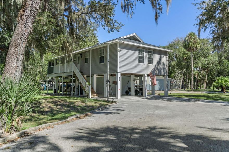 Welcome to your dream coastal retreat in the heart of Homosassa! (2024 ROOF) This stunning stilt home is nestled in a highly sought after canal community just off the world famous Homosassa River. Situated on an oversized 0.66 acre corner lot, this meticulously maintained property showcases true pride of ownership and offers the perfect blend of relaxation, recreation, and rental potential with short term rentals allowed. As you arrive, you'll appreciate the dual access driveway with plenty of space for vehicles, boats, and toys, plus RV hookups for added convenience. Step inside and you are greeted by high vaulted ceilings and breathtaking open water views of the peaceful canal. The bright and inviting kitchen sits at the heart of the home, fully equipped and thoughtfully designed with upstairs laundry, so there's no need to go up and down the stairs. Both the master and guest bedrooms are very spacious and comfortable, ideal for family or guests. The large screened in back patio is the perfect place to enjoy morning coffee or unwind in the evening as you take in serene views of the canal. Downstairs, you'll find your very own tiki bar awaits, perfect for entertaining, relaxing, and embracing the Florida lifestyle. The lower level also offers covered parking and storage space, as well as additional hookups for your RV or boat. Whether you're seeking full time living, a vacation getaway, or a turnkey short term rental investment (Airbnb, VRBO, etc.), this home is ready for it all. Best of all, this property can come partially furnished, and golf cart and toys are negotiable, just bring your toothbrush and start enjoying life on the water. Enjoy the best of waterfront living with several convenient boat launches and ramps just minutes away, providing direct access to the scenic Homosassa River and tranquil Mason Creek. After a day on the water, take a short golf cart ride through this welcoming, golf cart–friendly community to some of the area’s most beloved dining spots, including The Freezer, The Shed, and the Florida Cracker Monkey Bar—along with a variety of other charming local favorites offering fresh seafood, live music, and laid-back coastal vibes. Come on by and experience your slice of Florida charm with all the modern comforts you deserve. (2024 ROOF)