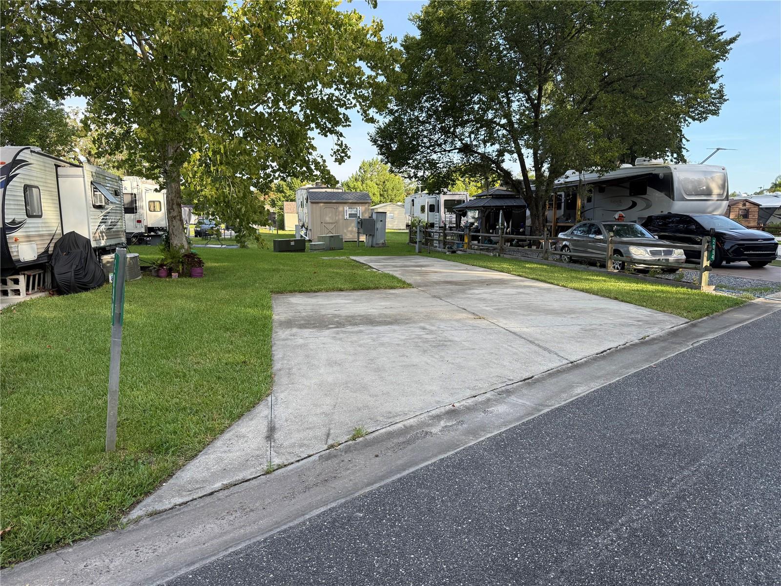 Welcome to 2848 NE 104th Terrace in the waterfront Wilderness RV Resort at Silver Springs, one of Central Florida’s most vibrant and amenity-rich RV communities. This beautifully shaded back-in lot is graced by a towering Big Maple Tree, offering cool, natural cover during those sunny Florida summers — an absolute gem for comfort and curb appeal. The resort itself is packed with high-end amenities including a sparkling pool, relaxing lodge, clean air-conditioned bathhouses, modern laundry facilities, and a full fitness center complete with both steam and dry saunas. There’s also a cozy recreation room with a pool table and dart board, perfect for unwinding or gathering with neighbors. Step just outside the gates and you're minutes from the legendary Silver Springs State Park — home to crystal-clear springs, kayaking trails, glass-bottom boat tours, hiking, and Florida wildlife at its finest. And when you're ready for a change of pace, head into historic downtown Ocala where The Square buzzes with life. Dine at one of many excellent restaurants, play a few games in the upstairs pool hall above Brick City BBQ, indulge your sweet tooth at the enormous vintage-style candy shop, or catch a show at the fully restored Marion Theatre, featuring a full liquor bar and a calendar packed with entertainment. Whether you're seeking a private retreat, a social getaway, or a rental-friendly investment, this lot delivers it all — charm, shade, and access to one of Florida’s most unique resort communities. Affordable HOA, pet-friendly, and golf cart ready — all just steps from adventure and relaxation alike.