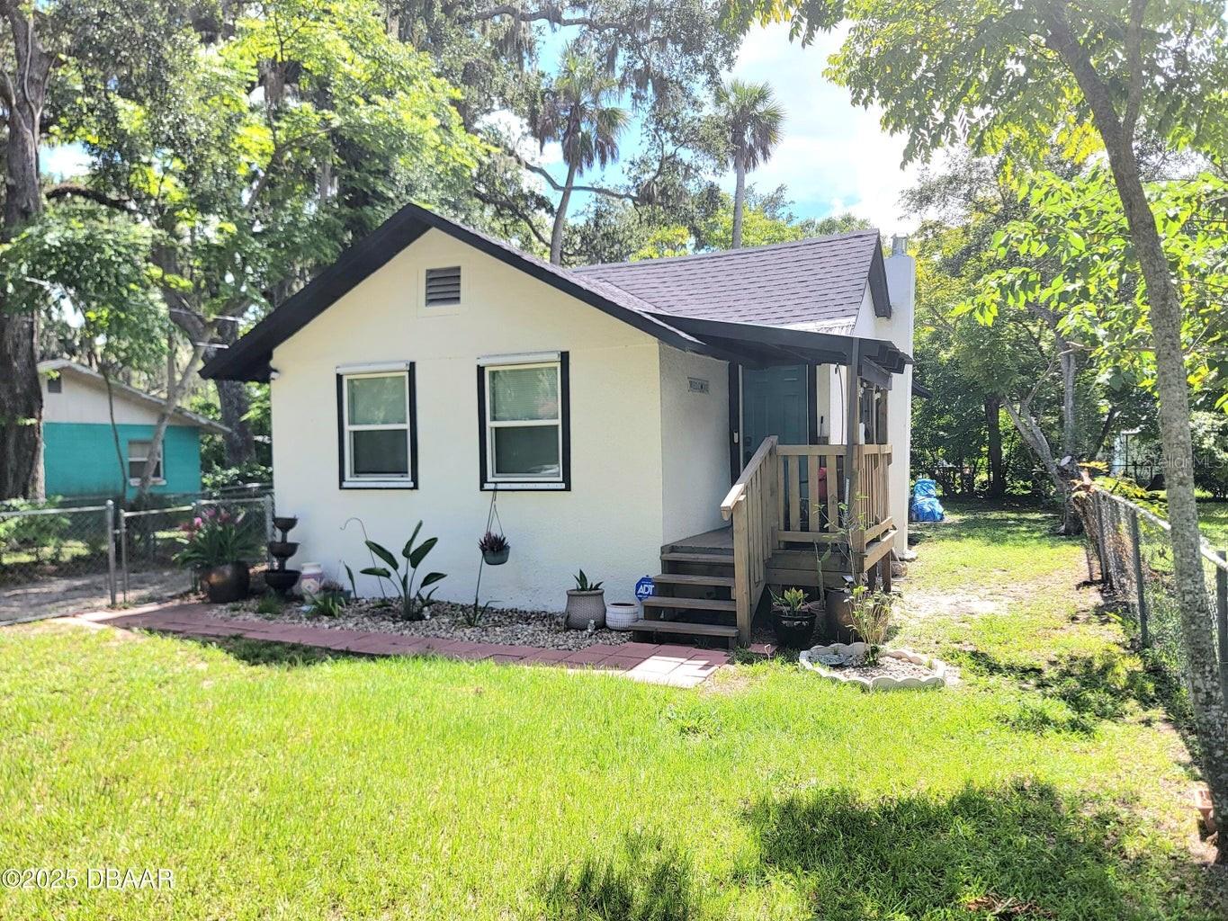 Discover the perfect blend of charm and modern style in this beautifully updated 3-bedroom home, located in the heart of Daytona Beach. Renovated in 2023 with an eye for detail, this quaint and charming residence offers peace of mind and contemporary living at its finest. Recent upgrades include a new roof (2023), new windows (2023) for enhanced efficiency, luxury flooring (2023), and so much more. In 2024, a new tankless water heater was also added, ensuring endless hot water and modern convenience. From the moment you arrive, you'll be welcomed by a long driveway leading to a double gate—ideal for RV or boat parking—and a fully fenced backyard. Step out back and find a spacious deck and patio area perfect for morning coffee, evening gatherings, or weekend cookouts. Surrounded by greenery and kissed by Florida sunshine, it's a picture-perfect setting to relax, and unwind. Inside, the open and inviting layout allows natural light to fill the home, creating a warm,
welcoming ambiance. This is more than a house, it's a turnkey coastal lifestyle, just minutes from world-class beaches, dining, and entertainment.