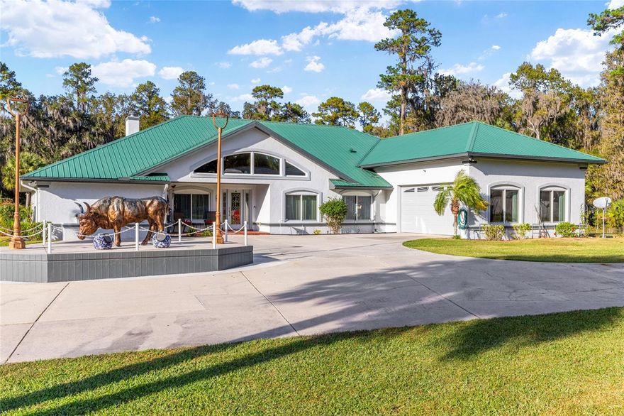 Ocala sportsman’s paradise, seven-plus acres, seven-bay garage and room to roam. Do you own your business? Need space for a home office, trophy room, game room or just room to breathe? Welcome to your ultimate Florida spread, a fully gated, nearly 7.5-acre estate in the heart of Ocala horse country, where luxury meets utility and every inch is built to impress. This is more than a home, it’s a lifestyle base camp. With over 4,000 square feet of upgraded living space, this three-bedroom, three-bath estate is packed with features that work as hard as you do. Whether you're running a business, collecting cars or just want a place to unwind, this property delivers. The workshop and garage setup you’ve been dreaming of includes seven-bay detached garage with a walk-in cooler, 1/2 bath and dedicated storage, ideal for tools, toys, boats or a serious home-based business. Massive detached workshop for projects, fabrication or gear storage. Two-car metal carport for overflow or guest parking. Electric run throughout the perimeter, ideal for holiday lighting, security or future expansion. Inside the home where comfort meets capability, including a chef’s kitchen with stainless appliances, center island, double sink, trash compactor and built-in desk. Stone wood-burning fireplace in the living room, with sliders to the Florida room. Primary suite with walk-in closet, private bonus room, and spa-style bath with dual vanities and glass-block walk-in shower. Fully furnished game room with pool table, bar stools and lounge seating, ready for poker night or game day. Dedicated office, two bonus rooms, and a Florida room for relaxing or entertaining. Upgrades that matter include new metal roof (2023), Anderson Windows (2019) for energy efficiency and sound control, new water tank (2025) and water heater (2023), four air-conditioning units for zoned comfort, water softener, new blinds and drapery included. The property is private, gated and gorgeous, with 7.34 acres of high-and-dry, usable land, fully fenced with a stunning electric gate at the entry. Gazebo and lanai for morning coffee or evening cocktails. Fenced dog run to keep your pets safe and happy. This is one of Ocala’s rarest finds, acreage, square footage and outbuildings that actually match the scale of the land. Whether you're a sportsman, entrepreneur or just want to live large with no compromises, this estate checks every box. Schedule your private showing today and see what it feels like to own a piece of Florida that works as hard as you do.