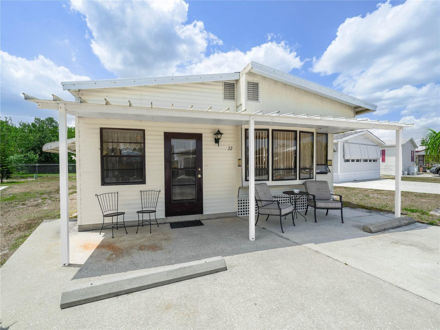 One or more photo(s) has been virtually staged. You don't want to miss this retro 1/1 turnkey home in the beautiful 55+ gated community of Saddlebag Lake Resort, where you OWN THE LAND!  Come for the winter or live here year round, this home is ready for you to move right in.  The spacious ground floor is a combination living and dining room, comfortably furnished so you can sit down and relax. The full size kitchen and breakfast nook are upstairs, with plenty of cabinets so there's a place for everything.  The hallway to the bedroom is where you'll find a pantry, laundry closet, complete with a washer and dryer ( 4 yrs.old), and a bathroom with tub and shower.  The water heater is just four years old. The home backs to the orange grove, so you'll have no rear neighbors.  You own the land here, and the low HOA dues includes your water, sewer and trash pick up, plus use of all the amenities. You'll feel like you're on vacation every day, with planned activities in the clubhouse, the sparkling community pool, screen enclosed hot tub, pickle ball and tennis courts, rec room with pool tables, fitness equipment and saunas, horse shoe pits and shuffleboard courts, not to mention fishing and boating in the lake!  The beach house has a commercial kitchen and a lake side covered patio, and are available for you to use at no charge for private parties, just reserve it. There's even a driving range and dog park at the back of the resort.  You owe it to yourself to check this out before it's gone, so call now!