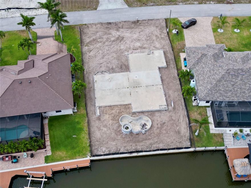 BEAUTIFUL GULF ACCESS LAND! Your Waterfront Dream Starts Here! Don’t miss this fantastic opportunity to own a premium Gulf access lot that’s already equipped with major improvements. Located on the NW CAPE CORAL between Old Burn Store and Burn Store — just bring your plans and finish building a beautiful 3 car garage home with 2189 sqft, survey and copy of the master plan available. Direct Gulf Access – A boater’s paradise with easy access to open water. Concrete Slab with Solid foundation and plumbing already in place, Private Seawall, Private Well, In-Ground Pool with hot tub!! Secure your shoreline with confidence. Saves you time and thousands in development costs. Located in a sought-after neighborhood with upscale homes, this lot offers the perfect blend of luxury, convenience, and waterfront lifestyle. No HOA, Quiet Street, Minutes to beaches, dining, shopping, Pine Island, Charlotte Harbor, and Matlacha Pass. Perfect for your custom dream home or investment project Drive by and see the potential for yourself!