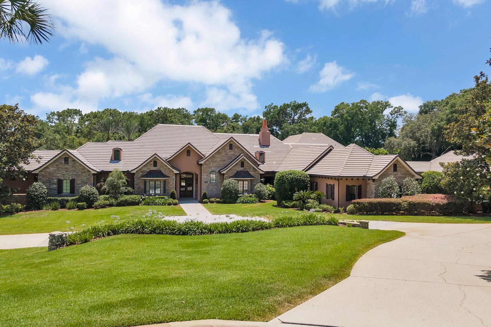 Welcome to 300 Grandview Place in the amazing guard gated and prestigious Sweetwater Club community! Embrace the true Florida indoor and outdoor lifestyle in this comfortable yet elegant custom resort style masterpiece is better than one of a kind! This home has incredible entertaining, living, enjoying, thriving and relaxing capabilities!
The showplace kitchen is ready for the casual cook or the serious chef with Viking Appliances, a 6 burner gas stove, multiple refrigerators and dishwashers, a very functional large pantry, a butler style formal pantry, soaring high beamed ceilings and a wall of windows letting in great light and looking over the beautiful pool!!
There are 7 large bedrooms, 6 of these bedrooms are en-suite, 7 full bathrooms, 3 half bathrooms, a great home office, a multi-purpose room near the office that could be used as a gym or nursery, an 8 seat movie room, a large game room with a full bar, upstairs bonus room and more...
The main bedroom suite is very well appointed with soaring beamed ceilings, a giant bathroom with two private water closets, two enormous wardrobe closet areas, an attached room that is currently a gym but could be a nursery/sitting room/study/etc..
There is a soundproofed music room, play the trumpet as loud as you like!! The main dining room has an incredible fireplace and room for many!! The bar and game room opens fully to the giant porch and also connects to the eight seat home theater..
The living area of this home fully opens to a 1300 square foot covered patio, the game room, outdoor kitchen, family room all become one space with space to entertain hundreds of your friends or just relax with a book!! The low maintenance salt water pool and spa complex is amazing, the spa is right off the main bedroom porch, the resort style pool is partially in the screen and partially outside and must be seen!!
The nearly 3000 square foot garage area has 8 garage doors, yet ihas the space to house more than 8 vehicles, the giant motor court is large enough to have your own car show!!
The home has a fully lit pickleball or tennis court with a basketball hoop as well! The manicured 3.67 acres are incredible as well as everything else!!
Come home and enjoy all the wonderful Sweetwater Oaks amenities!! The amenities include access to Sweetwater Beach at Lake Brantley which offers a beautiful park and beach as well as boating, water skiing, fishing, sailing, kayaking and fun, six tennis courts, 8 pickle ball courts, sand volleyball at Sweetwater Beach, parks, multiple playgrounds, and community events!! Access to the Wekiva River is right down the street at Riverbend Park, enjoy soccer, baseball, kayaking, canoeing, fishing, nature walks and much more! The schools are the best in the area; Sabal Point Elementary School, Rock Lake Middle School and nationally ranked Lake Brantley High School!! The location, quality and condition are unreal, call today to see this grand estate!!
