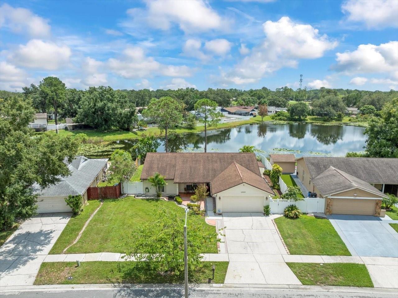 Charming 4-Bedroom, 2-Bathroom Home with Pond Views, Open Layout & Spacious Backyard Retreat. Welcome to this beautifully maintained single-family home that perfectly combines modern convenience, thoughtful design, and timeless charm. With 4 bedrooms, 2 bathrooms, and 1,696 square feet of living space an ideal fit for anyone seeking a comfortable and inviting retreat. Inside you will experience the warmth of an open layout, where the main living areas flow seamlessly together, creating a bright and inviting atmosphere. The spacious living room is filled with natural light and offers direct access to the outdoors through elegant French doors. At the heart of the home is the spacious kitchen, designed with functionality and style in mind. The primary bedroom suite serves as a peaceful escape, complete with a private en-suite bathroom and walk-in closet for added comfort and convenience. The additional bedrooms share a guest bath with walk-in shower. Step outside and enjoy your very own backyard retreat. The covered patio offers a wonderful space for outdoor dining or entertaining, while the large, fenced-in backyard provides both privacy and room for recreation. Mature landscaping enhances the beauty of the space, and the tranquil pond view adds a serene backdrop that can be enjoyed year-round. Outdoor shed on the side of the home offers additional storage options. Great location near shopping, dining and highways, also located in the A-rated Steinbrenner school district.
