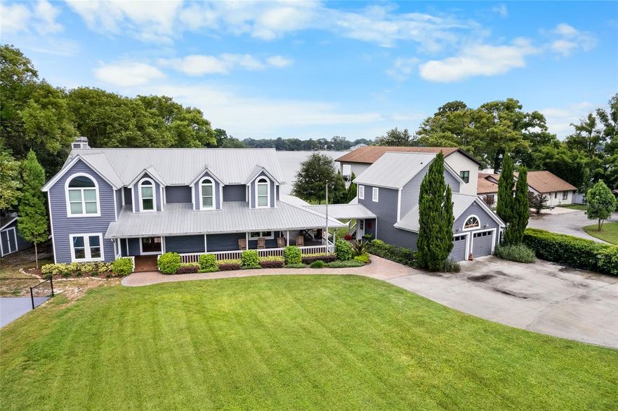 Rare opportunity to own this stunning Lake Carroll Estate.  Sitting on over an acre, this incredible property features a Large main home overlooking Lake Carroll, a guest home, a detached garage with above apartment and so much more.  The Craftsman style home boast 5 bedrooms, 3 baths with a welcoming wrap-around porch.  A gourmet kitchen with Wolf and Sub-Zero appliances, features a dinette with gorgeous views of the lake.  Enjoy diner in the dining room with vaulted ceiling.  Comfortable family room with flagstone fireplace just off the dining space.  A Florida room, currently being used as a gym, opens to the pool deck.  Downstairs also features a large laundry and pantry space, with a laundry shoot from the second floor.  A full bath sits off the kitchen.  The 5th bedroom is being used as office on the first floor.  Upstairs is where you'll find the large primary bedroom with sliders that open to a private balcony.  Immense owners bath with separate tub and shower and dual vanity and walk in closets.  Three additional bedrooms, one with a private deck as well, and the third bath finish out the top floor.  Outside on the lake, you find a covered boat dock with a lift and space for additional water craft.  The fire pit is the perfect place to relax.  Additional recreational opportunities exist with the full size Pickleball court, basketball goal and in-ground trampoline.  The detached garage has space for two cars and plenty or storage.  A workshop sits behind the parking space.  Above is a finished one bed, one bath apartment with kitchette.  The two bed one bath cottage sits on the northwest corner of the property and has been updated as well.  Perfect for guests or family or even as a rental.  This estate presents an incredible opportunity!   Schedule your private viewing today!