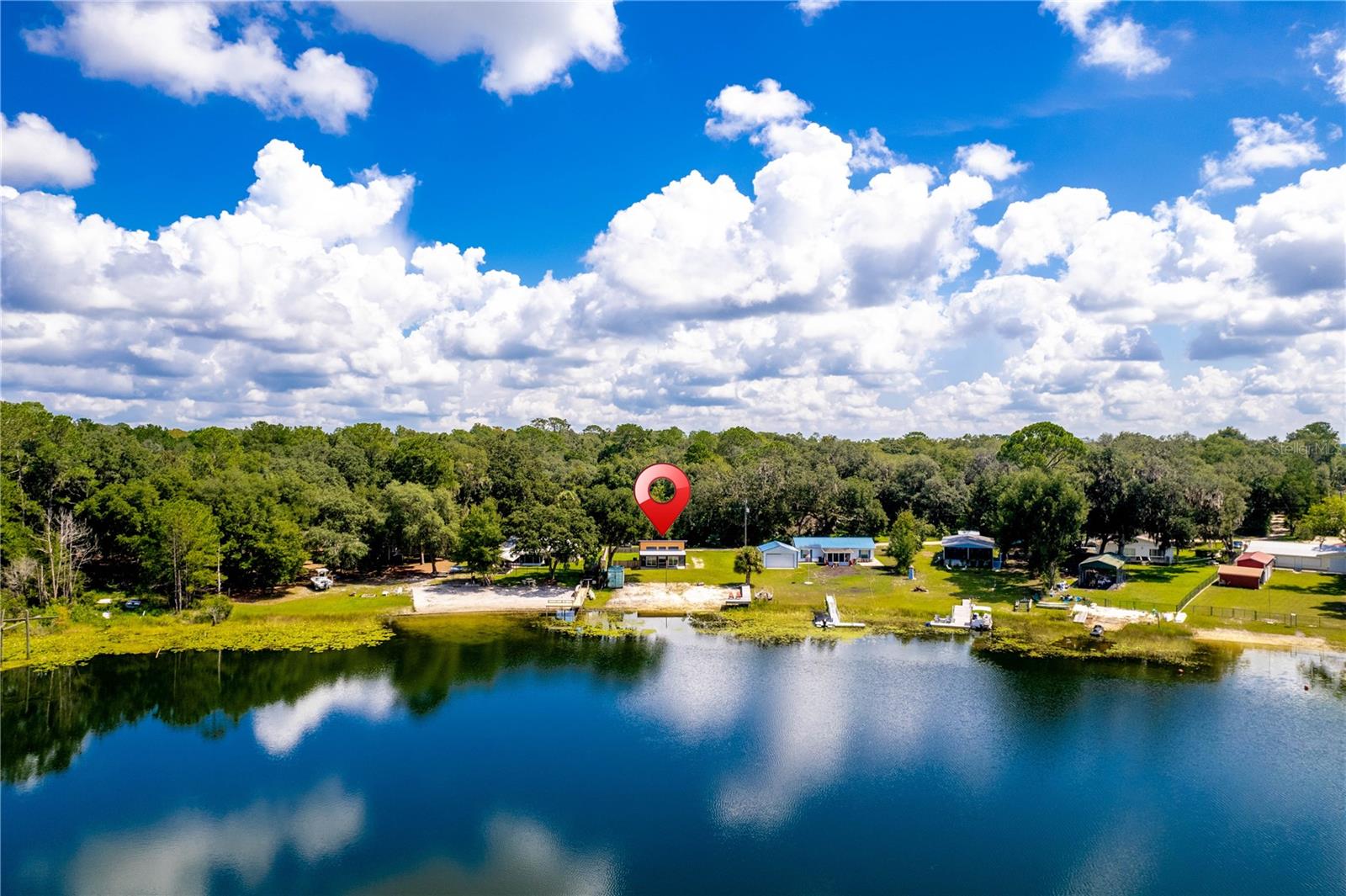 Florida Living at its finest! This truly one-of-a-kind home is located on Lake Owens & is an absolute breath of fresh air to visit! Built in 2021, this Lakefront 2 bedroom 1 bathroom modern tiny home is the perfect place to call home! Enjoy the lakefront sunsets of Lake Owens from your own private dock & beach. From your covered back porch, entertain guests in your large yard. As you walk inside the home you immediately notice the open feel of the floorplan & the vinyl flooring stretching throughout the home. The vaulted ceilings, sliding glass doors, & additional windows brighten up the main living space. The kitchen showcases modern granite countertops, white shaker cabinets, and stainless steel appliances. The bathroom is also modern with unique glass tiles in the shower, granite countertops, & white shaker cabinets. This unique home was built using 2x6 walls, 5 inches of spray foam insulation, energy efficient windows and sliders. Out back, there is a fenced in yard perfect for dogs or storing boats or campers. Also, there is a large container on the property, perfect for storage. This home truly is a must see!