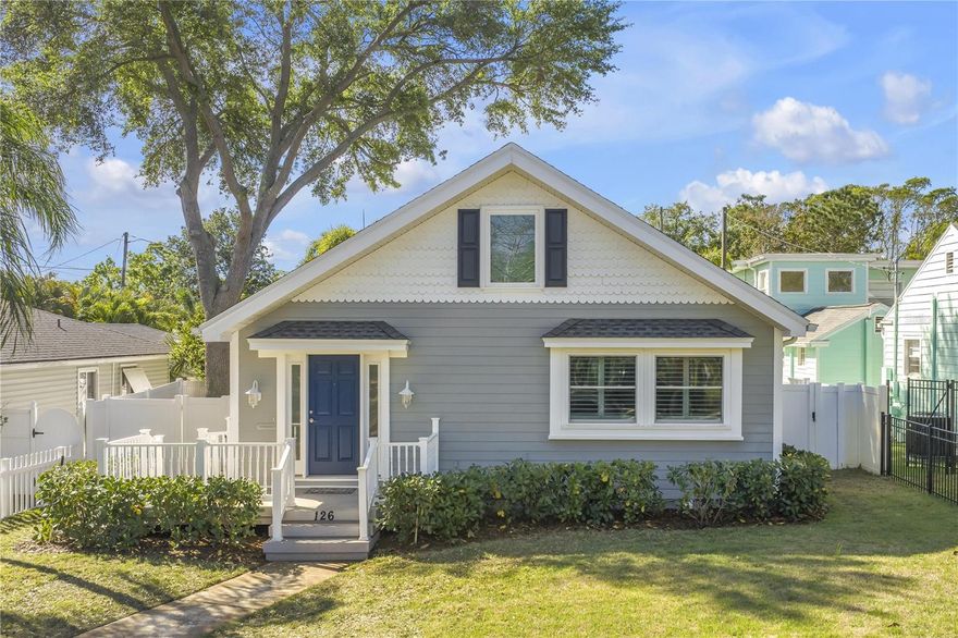 Welcome to 126 30th Ave N, a charming, character-filled Florida bungalow with timeless appeal and thoughtful updates—this home blends classic design with everyday comfort. From the moment you arrive, the inviting front porch and fresh coastal-inspired exterior set the tone. Inside, you’re welcomed by a warm, light-filled entry with soaring vaulted ceilings that lead to the living space featuring rich wood ceilings, gleaming hardwood floors, and architectural details that add depth and personality. The open yet defined layout offers comfortable living and entertaining areas, while large windows bring in natural light throughout. Unique details like custom niches, stylish lighting, and a statement ceiling create a memorable interior that stands out from typical listings. Three bedrooms and two baths, including a spacious primary suite with a private bath and walk-in closet, a guest bedroom with a generous closet, and a versatile third bedroom ideal for a home office or additional guest space. Convenient indoor laundry closet is perfectly situated in the hallway. An updated, modern kitchen features stainless steel appliances and is adjacent to the spacious family room and dining area that overlook the backyard. Custom features include crown molding, Plantation shutters, a built-in entertainment hutch with display shelving in the family room. French doors lead outside, where you will enjoy a spacious paver patio and yard with room to relax, garden, or entertain—perfect for enjoying Florida living year-round. A detached garage, along with a separate Florida porch/storage area, offers excellent additional storage. The alley-access garage also features an off-street parking pad for added convenience. White vinyl fencing and lush tropical landscaping provide privacy and a serene outdoor setting. Major upgrades bring peace of mind - 2021 roof with hurricane clips for insurance savings, hurricane-impact windows that fill the space with natural light while boosting efficiency and security, 2025 water heater, and well maintained AC system & excellent insulation for year-round comfort. Situated at the north end of Old Northeast neighborhood, the home is just steps from Coffee Pot waterfront park offering waterfront views and plenty of space to enjoy outdoor activities including a fenced playground, picnic shelter, public boat ramp and kayak rack. A dedicated bike path connects you to downtown St Pete and many shops and restaurants are within walking distance. Perfect for buyers seeking something beyond cookie-cutter construction, this exceptionally well maintained home offers warmth, style, and individuality—all in a highly desirable setting.