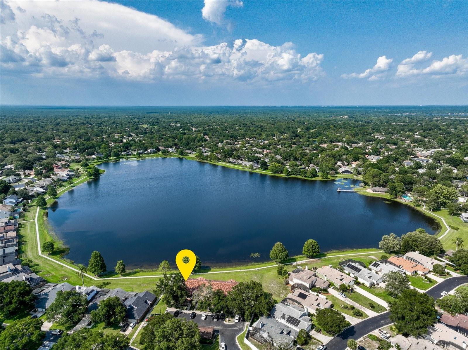 Homeownership opportunities like this do not come often! Beautiful first-floor, three-bedroom condominium located in Wekiva Cove, overlooking gorgeous lake views and a walking trail. Floor plan is open and airy, along with 9-foot ceilings within this well-maintained beauty. Communal areas in the home are handsomely situated, along with a clear view of a covered patio facing the lake to enjoy a cup of coffee in the morning. Eat-in kitchen is well thought-out, with lots of storage, meal prep and separate bar. French doors in the secondary bedroom allow for an optional office. The primary bedroom is the perfect size, with unobstructed views of the lake. Each unit has its own separate storage area to keep holiday items safe or any other stowaways. Community has one-car garages for each of its owners. Plantation shutters, inside laundry with washer and dryer combo. Amenities for this community: Tile roof, sparkling community pool, clubhouse, tennis courts, pickleball, playground and park, community walking trail 1.5 miles around Lake Wekiva, community sports field, and of course, Seminole County schools. Very rare when these condominiums become available; call today!