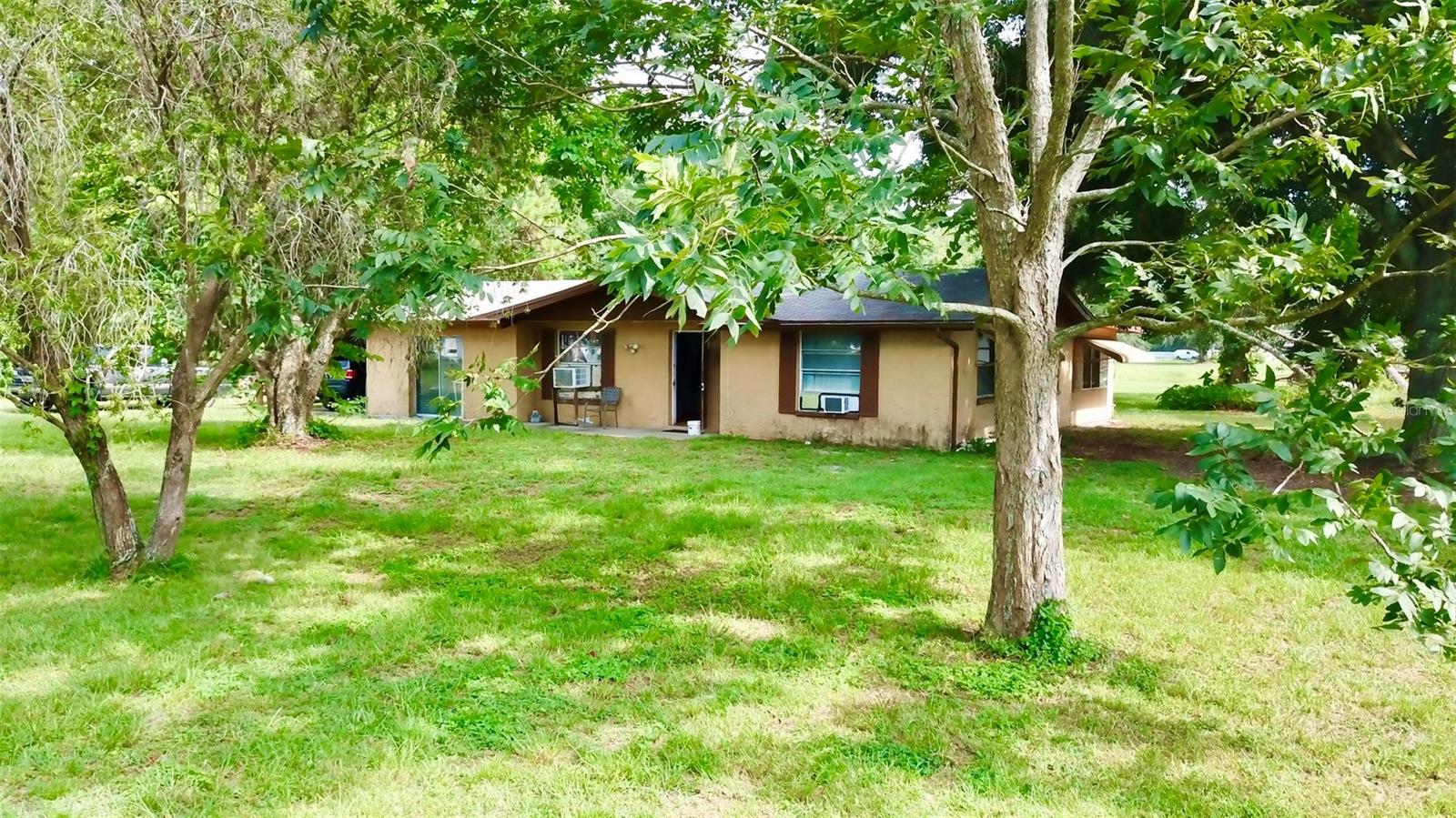 Two houses on one 2 acre lot with deep (50-60 feet deep) AS IS double fixer-upper. Just minutes from Downtown New Port Richey; so close you could get there in a golf cart sits this quaint lot that has been in the same family for many decades and the original man dredged the pond super deep as that was his full time job in life and so this pond is perfect for any licensed divers as well as you could have chicken, horses, cows whatever one would desire. The front of the property has a home that is 2 bedrooms 1.5 baths and has some extra living spaces within along with a covered back porch. The garage area currently has a glass sliding door instead of a garage door. There is also an old storage shed that is there but falling apart along with a larger concrete pad where one could put a steel or wooden building. The rear house is right near the pond and has a beautiful view out the back all day long but the rear home is severely neglected and will need new life breathed into it. This package could be an absolute diamond but will take some serious remodeling. Would make a great income property as well as primary residence and is zoned AR so you could run your business out of your home here depending on what you do for a living. CASH ONLY AND PRICE IS FIRM, Inquire within and private appointments only.
