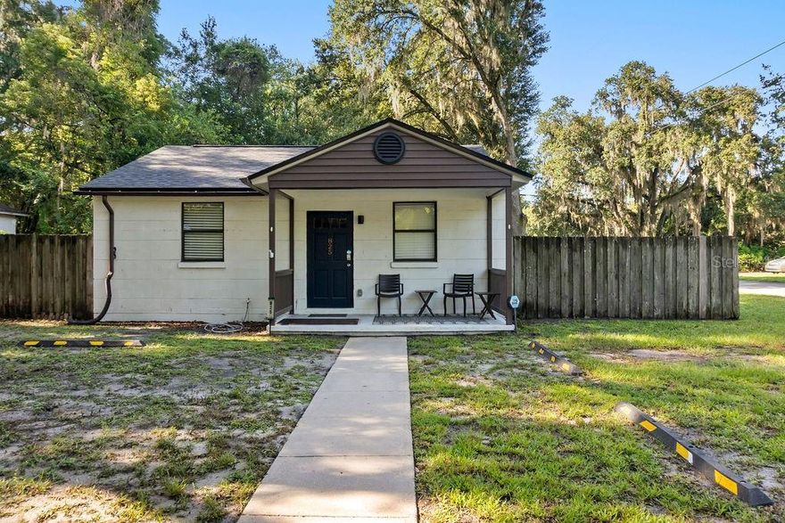 This charming 2-bedroom, 1-bath home just under 900 square feet sits on an almost quarter-acre corner lot and has been thoughtfully updated. The home is being sold fully furnished, making it a perfect turnkey Airbnb (historically has been and financials are available), investment property, or move-in ready home. Conveniently located with close access to UF, downtown, and Shands, the property offers both strong rental appeal and everyday convenience. Extensive recent improvements mean the heavy lifting has already been done. The home features all new interior and exterior paint (December 2023), a new roof (February 2024), all new electrical (April 2024), and new water and sewer piping throughout (January 2025). The water meter and supply lines were also replaced by the City in December 2024, adding additional peace of mind. The completely updated kitchen (February 2025) includes new appliances along with cookware, dishes, and essentials included in the sale. A water filtration system serving both the kitchen and bath (January 2025) provides clean, filtered water, and an electric water heater located beneath the bathroom sink offers efficient hot water delivery. Comfort systems have also been maintained, with the AC inspected and serviced (September 2025). The property is being sold as-is and fully furnished, including furniture, bedding, towels, kitchenware, appliances (only the dryer is older), and cleaning supplies—everything needed to operate immediately as a short-term rental or enjoy as a low-maintenance home. The large corner lot offers additional development potential, with the ability to split the lot and sell separately or build an additional unit at the rear of the property (buyer to verify with the city). A rare opportunity to purchase a fully equipped, recently updated home with income and future development potential.