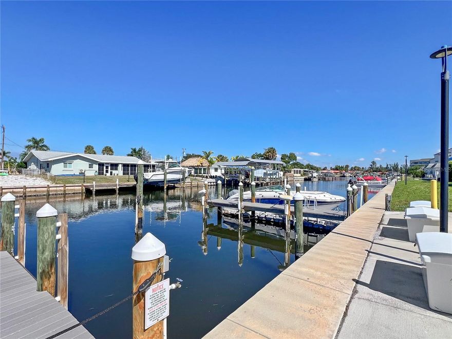 Welcome to 9811 Hernando Court, where coastal living meets exceptional value just minutes from Anna Maria Island and the Gulf of Mexico. TURNKEY FURNISHED! This charming condo offers the sought-after Southwest Florida boating lifestyle without the premium price of island living. Step inside to discover a light and airy interior with a comprehensive list of recent upgrades from top to bottom. Including all windows being hurricane rates. The open floor plan features coastal-inspired finishes and plenty of natural light. Enjoy peaceful mornings and colorful sunsets from this unbeatable location just minutes from this historical Cortez fishing village. The spacious kitchen is perfect for entertaining, while the primary suite offers comfort and storage with its updated bath and generous closet space. Guests will enjoy their accommodations too, with a private second bedroom and bathroom. The community is thoughtfully designed to enhance your lifestyle, featuring boat docks that are available on a first come first serve basis for a low fee, a private kayak launch, heated pool, and clubhouse. It’s pet-friendly for both dogs and cats, and monthly fees conveniently cover all insurances, building and grounds maintenance, water, sewer, garbage, cable TV, and high-speed internet. Boaters will appreciate the deep-water canal with no fixed bridges, allowing quick access to open water. Whether you're seeking a full-time residence or a seasonal retreat, 9811 Hernando Ct offers a rare opportunity to enjoy true waterfront living near Anna Maria Island’s world-famous beaches, dining, and coastal charm. Come see for yourself today!