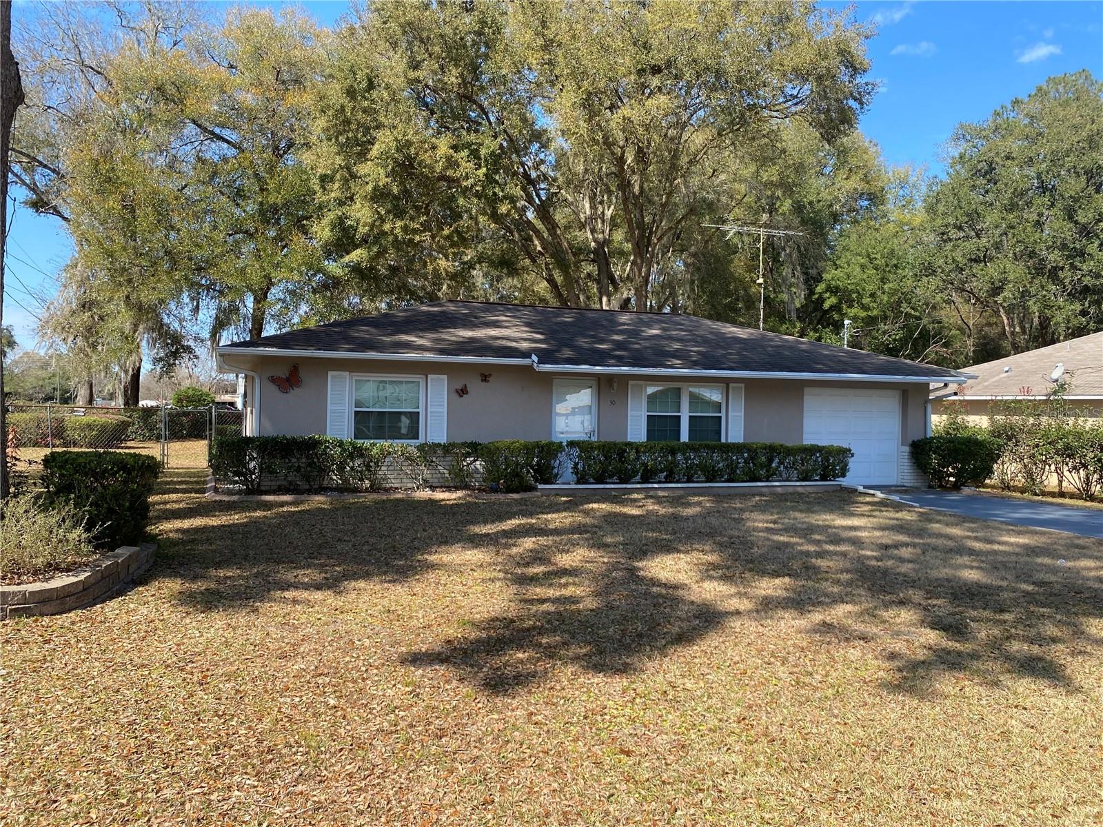 Adorable 2/1 on .25 acre corner lot with chain link fenced back yard. This home is the perfect home for 1st time buyers, retirement or investment property. Home features wood floors, ceiling fans, nice screened tiled back porch area & 12 x 6 storage unit. NEW SEPTIC TANK. If you love the outdoors, the home is located near the Ocala National Forest, Devil's Den Prehistoric Springs, 15 mins from the Silver Springs State Park.