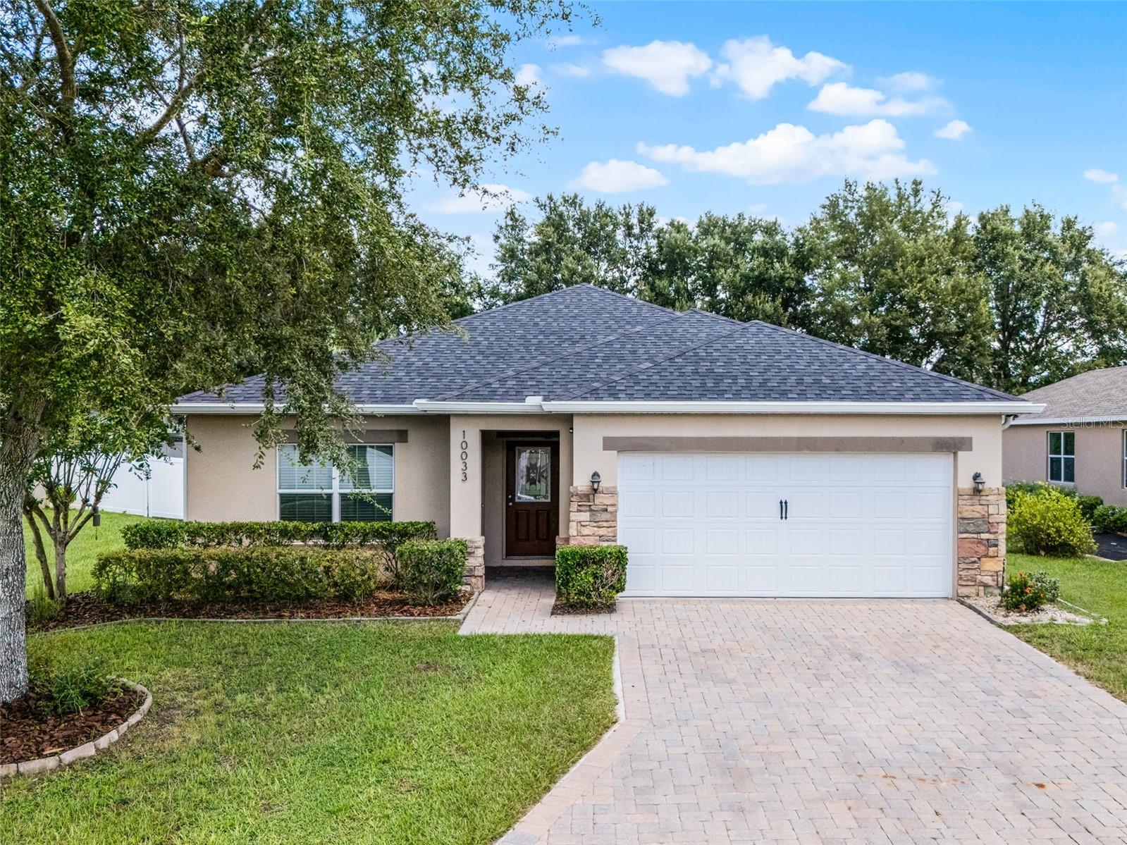 Welcome to your dream home in the gated community of Barrington Estates, nestled among the rolling hills of Clermont. At 10033 Stockbridge Street, you’ll find the perfect blend of modern upgrades and peaceful charm. This move-in ready residence has been beautifully refreshed within the past 2 years features mature peach, lime, and lemon trees, a new 160MPH wind-rated roof (2023) including extra water barrier protection, 6” seamless gutters, and a new garage door system (2024). Inside, enjoy a brand new Carrier A/C (2025), updated kitchen with new dishwasher and disposal, renovated bathrooms with quartz counters, and new vinyl flooring in three bedrooms (2025). A new PGT sliding door adds style and efficiency. Every detail has been thoughtfully upgraded for comfort, durability, and peace of mind! Living here also means being just minutes from some of Clermont’s best attractions Lake Louisa State Park, with miles of hiking, biking, and kayaking opportunities The Florida Citrus Tower, offering sweeping views of Central Florida The Showcase of Citrus, a family-friendly U-pick farm with monster truck tours and a country market Historic Downtown Clermont, filled with breweries, shops, farmers’ markets, and lively community events and not to mention Lakeridge Winery & Vineyards, where you can enjoy tours, tastings, and local wines! If you’re looking for a home that offers serenity, modern updates, and unbeatable access to Clermont’s best outdoor adventures and attractions, this one checks every box.