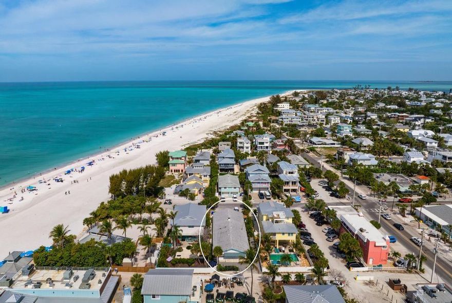 For Investors looking to purchase property on the desirable north end of the Anna Maria Island, this unique and rare 4-unit apartment building is an exceptional investment opportunity.  Welcome to Gulf Queen Apartments just 50 feet from the sugary sandy beaches of Anna Maria Island. Situated on nearly 7,400 sq ft lot, the property also presents future redevelopment potential—offering investors the flexibility to build new in this prime coastal location.  This turnkey furnished, ground level 4-plex has two apartments with two bedrooms and one bathroom; and two apartments with one bedroom and one bath.  Gulf Queen Apartments offers immediate income potential in one of Florida’s most sought-after beach markets.  The units showcase polished terrazzo flooring, open-concept living and kitchen areas, and tasteful coastal décor. Recent upgrades include renovated kitchens with granite countertops, updated bathrooms, and new furnishings throughout—creating an inviting, guest-ready environment. The 2-bedroom units comfortably accommodate up to four guests, making the property ideal for group bookings such as family vacations, reunions, or wedding parties. Anna Maria is known as a desirable wedding destination. The entire building can be rented out to accommodate wedding guests or other family gathering venues, or each unit can be rented individually. The property also has two golf cart charging stations to accommodate guests who want to tour the island in their rented golf cart. The property is located next door to the Sand Bar Restaurant which hosts many wedding guests from around the world each year. The property is also located on famous Pine Avenue, a street that runs from Tampa Bay to the Gulf of Mexico.  The property's 107 Pine Avenue address is walkable to numerous shops and restaurants that stretch from the Bay to the Gulf.  The location is unmatched—just steps to the beach, as well as the vibrant shops and dining along Pine Avenue, and convenient access to the free island trolley. Guests can easily stroll or bike to Bean Point, or enjoy nearby favorites like The Waterfront Restaurant and The Sandbar Restaurant.  Whether you’re seeking a vacation rental portfolio or a redevelopment opportunity in a premier beach destination, Gulf Queen Apartments delivers value, location, and income potential. Vacation Rental bookings available upon request.  Call for a private viewing of this unique property today.