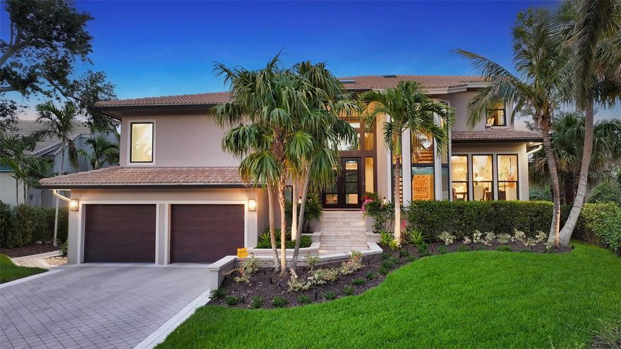 Welcome to the exclusive, double-gated Bay Isles Bayou community on Longboat Key, where privacy meets refined coastal living. This stunning waterfront residence sitting on 0.28 acres has undergone a complete, top-to-bottom renovation and now showcases 115 feet of serene waterfront frontage—a tranquil setting frequented by swans, otters, and a variety of native birds.  From the moment you arrive, the architectural impact of the custom 20-foot front entry and the oversized impact glass windows and doors—featured throughout the entire home—sets the tone for the level of craftsmanship within. Designed for both beauty and resilience, these premium installations provide the ultimate in storm protection and long-term peace of mind. Inside, the kitchen is a true showpiece, thoughtfully designed with a full tile wall backsplash, Campbell solid wood cabinetry with panel-front appliances, a striking quartzite waterfall island with a custom oversized sink and dual faucets, and an elite suite of appliances including a Sub-Zero refrigerator and freezer, Sub-Zero drawer beverage coolers, Wolf gas range, Miele wall oven, in-wall coffee system, steam oven, and Cove dishwasher. Wide-plank, high-end engineered hardwood flooring flows seamlessly throughout the home. The custom staircase with glass panel railings adds a sleek modern touch and enhances the open feel of the interior. The owner’s suite is a sanctuary overlooking the water, and its spa-like bath is straight from the pages of *Architectural Digest*, featuring Campbell custom cabinetry, walls of designer mirrors, and exquisite statement lighting. A brand-new resort-style heated and saltwater pool with a picture-frame screen enclosure offers uninterrupted views of the water and the lush, professionally landscaped surroundings. The oversized two-car garage includes an air-conditioned storage room for added convenience. This is more than a renovation—it’s a reimagining of luxury coastal living, finished with the highest attention to detail and quality. As a resident of Bay Isles, you’ll enjoy deeded access to the private Bay Isles Beach Club, as well as proximity to the Longboat Key Club’s renowned golf, tennis, spa, dining, and marina amenities. Just moments from Publix, the tennis center, town library, and local art shows, and a short drive to St. Armands Circle, Downtown Sarasota, and SRQ Airport—this home delivers the very best of Longboat Key living.