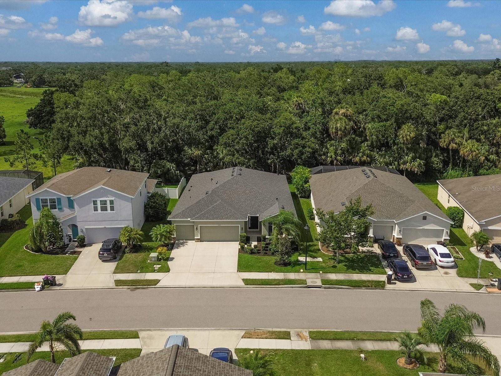 Welcome to your dream home in the peaceful, gated community of Del Tierra! This stunning 3-bedroom, 3.5-bath open-concept residence offers over 2,500 SqFt of thoughtfully designed living space and has been meticulously maintained by the original owner with updates throughout. Key Features Include: New Roof (11/2024), New Carpets in all bedrooms, and Freshly Painted Interior & Exterior. Step inside and immediately be captivated by the breathtaking view of your private backyard oasis, framed by large sliding glass doors that flood the home with natural light. This home blends comfort, elegance, and functionality at every turn. Just off the foyer, you'll find the first bedroom with plush carpeting and a built-in closet with built-in shelving. Adjacent is a full bathroom featuring granite countertops, a tub/shower combination, and elegant ceramic tile. A cozy den or home office with French doors offers privacy and flexibility, ideal for remote work or a quiet retreat. The heart of the home opens to a spacious great room and a chef-inspired kitchen designed to impress. The kitchen features: Stainless steel appliances including LG refrigerator with dual ice maker, GE range, microwave, and dishwasher, oversized granite island with garbage disposal, full-height coordinating backsplash and soft-close wooden cabinetry, Generous pantry with spice rack. Abundant of electrical outlets for your kitchen gadgets throughout the kitchen. The dining area is thoughtfully placed just off the kitchen, perfect for everyday meals or entertaining guests. The great room includes three floor outlets for discreet cable management and is prewired for surround sound. Bedrooms, lanai, and garage are prewired for speakers. Retreat to the luxurious master suite, complete with a tray ceiling, ceiling fan, private lanai access, and two walk-in closets. The en-suite bathroom features dual granite vanities, a soaking tub, a glass-enclosed shower with a bench, and a separate water closet for privacy. The third bedroom makes a perfect guest suite with its own walk-in closet, and a private en-suite bathroom with a granite vanity and walk-in shower. Step outside to your fully screened-in lanai oasis featuring a working hot tub, ceiling fan, and peaceful views of your private backyard. There's even a convenient half bath under air with a granite countertop sink. The laundry room offers wooden cabinetry, a storage room with shelving, and LG washer & dryer, all situated near the entrance to the oversized 3-car garage. The garage boasts epoxy flooring, dual door openers, built-in cabinets, a utility sink, a workbench, and hurricane shutters with hardware. The property also includes a 4-zone irrigation system powered by reclaimed water to keep the landscaping lush and low-maintenance and aluminum gutters. Minutes to SR-64, I-75, and Ft. Hamer Bridge. Close to Gene Witt Elementary (bike ride away). Nearby shopping including Costco, and many more! Residents of Del Tierra enjoy access to a resort-style pool, fitness center, and gated entry all while being surrounded by nature and tranquility. This home truly has it all: elegant design, thoughtful upgrades, and an unbeatable location. Don’t miss the opportunity to make this beautiful home yours!