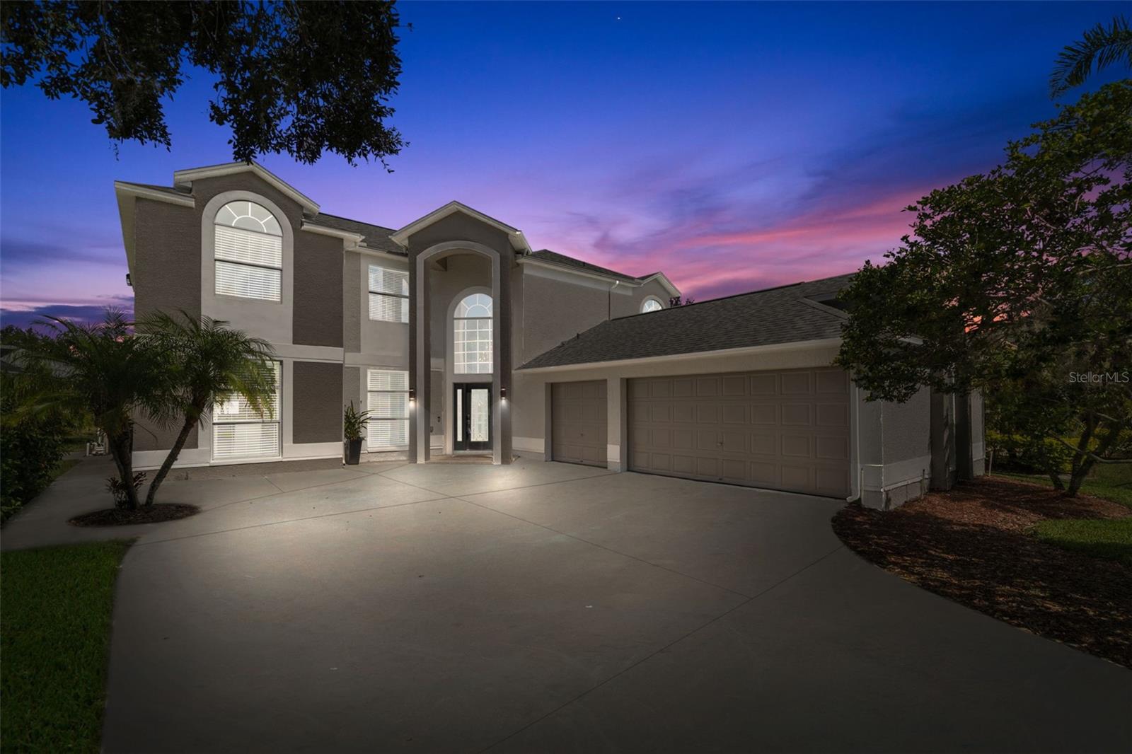 One or more photo(s) has been virtually staged. Welcome to this stunning 5-bedroom, 3,294 sq ft home located in the desirable Worthington subdivision of the gated East Lake Woodlands Golf Course community. This residence offers the perfect combination of luxury, comfort, and functionality, with high-end finishes, thoughtful updates, and a resort-style outdoor oasis designed for year-round Florida living. As you arrive, you’ll be greeted by a grand 18-foot entryway accented by a Swarovski chandelier and soaring ceilings that create a bright and elegant first impression. Inside, the home’s open-concept floor plan offers both formal and casual living areas, including a formal living and dining room, a spacious family room, and a beautifully remodeled kitchen that is truly the heart of the home. The kitchen features Bosch appliances (including a 2023 refrigerator), a marble backsplash, 42” cabinetry with crown molding, pull-outs, a lazy Susan, buffet counter, wine storage, and a breakfast bar. A downstairs guest bedroom with half bath adds convenience and flexibility for visitors or multi-generational living. Throughout the home, you’ll appreciate the stylish flooring—no carpet—for a sleek look and easy maintenance. Upstairs, retreat to your expansive primary suite, complete with dual walk-in closets, a sitting area with speaker wiring, and a fully remodeled marble en suite bathroom featuring a soaking tub, step-in shower, dual-sink vanity, and private water closet. Three additional upstairs bedrooms are generously sized and offer excellent storage space, making this home ideal for families or those who love to host. Step outside to your own private paradise. The solar-heated pool and spa feature Baja shelves, waterfalls, and a newer screen enclosure (2023). The outdoor kitchen and covered entertaining space make this the perfect spot for alfresco dining, evening gatherings, or simply relaxing while enjoying the lush landscaping that provides both privacy and tranquility. Additional upgrades include smart home security and thermostats, a newer A/C (2023), water heater (2024), and a 2017 roof for peace of mind. The oversized side-entry 3-car garage offers storage, yard access, and plenty of room for vehicles, hobbies, or additional organization. Living in East Lake Woodlands means access to a premier lifestyle, with optional memberships available for golf, tennis, pool, and clubhouse amenities. The community is also conveniently located near top-rated schools, shopping, dining, and beautiful nature trails, all while being a short drive to Tampa, St. Petersburg, and award-winning Gulf Coast beaches. This turn-key home is fully remodeled, energy-efficient, and move-in ready, offering everything today’s buyers are searching for with no costly updates required. Don’t miss the opportunity to call this remarkable property your new home—schedule your private showing today and experience the best of Florida living in East Lake Woodlands!