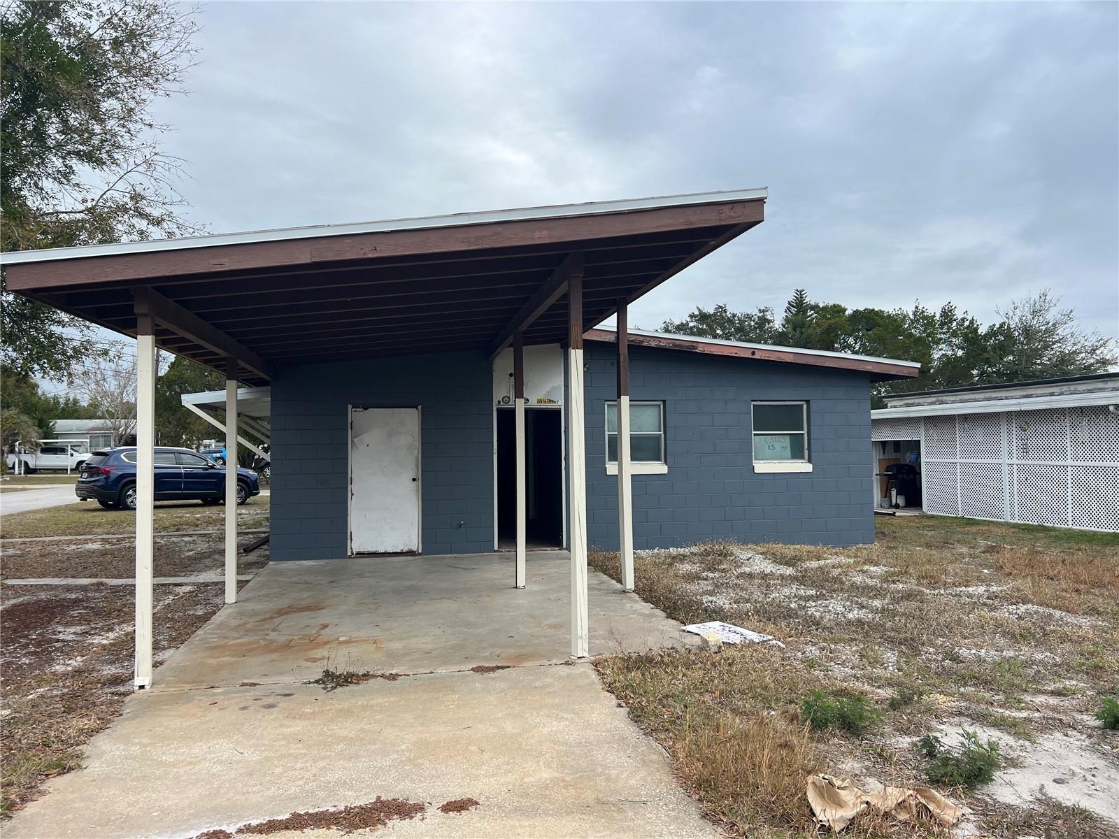 "DIAMOND IN THE ROUGH! This charming block home in a 55+ community is waiting for your personal touch. Highlights include a brand-new roof and AC unit, plus all the paint needed to give the exterior a fresh new look. Appliances are included, ready for hookup, and light fixtures are provided, just waiting to be installed. Enjoy the peaceful surroundings on this spacious corner lot, perfect for a king (or queen) of the castle. With an HOA fee of just $23/month, you'll have access to a golf cart-friendly community, complete with routes to downtown Tavares' scenic sunsets, restaurants, and shops. Plus, crossing 441 by golf cart is a breeze, giving you easy access to even more amenities. Don't miss this opportunity to put your stamp on the perfect home. This is a fixer upper, and no repairs will be offered. Sold AS IS!